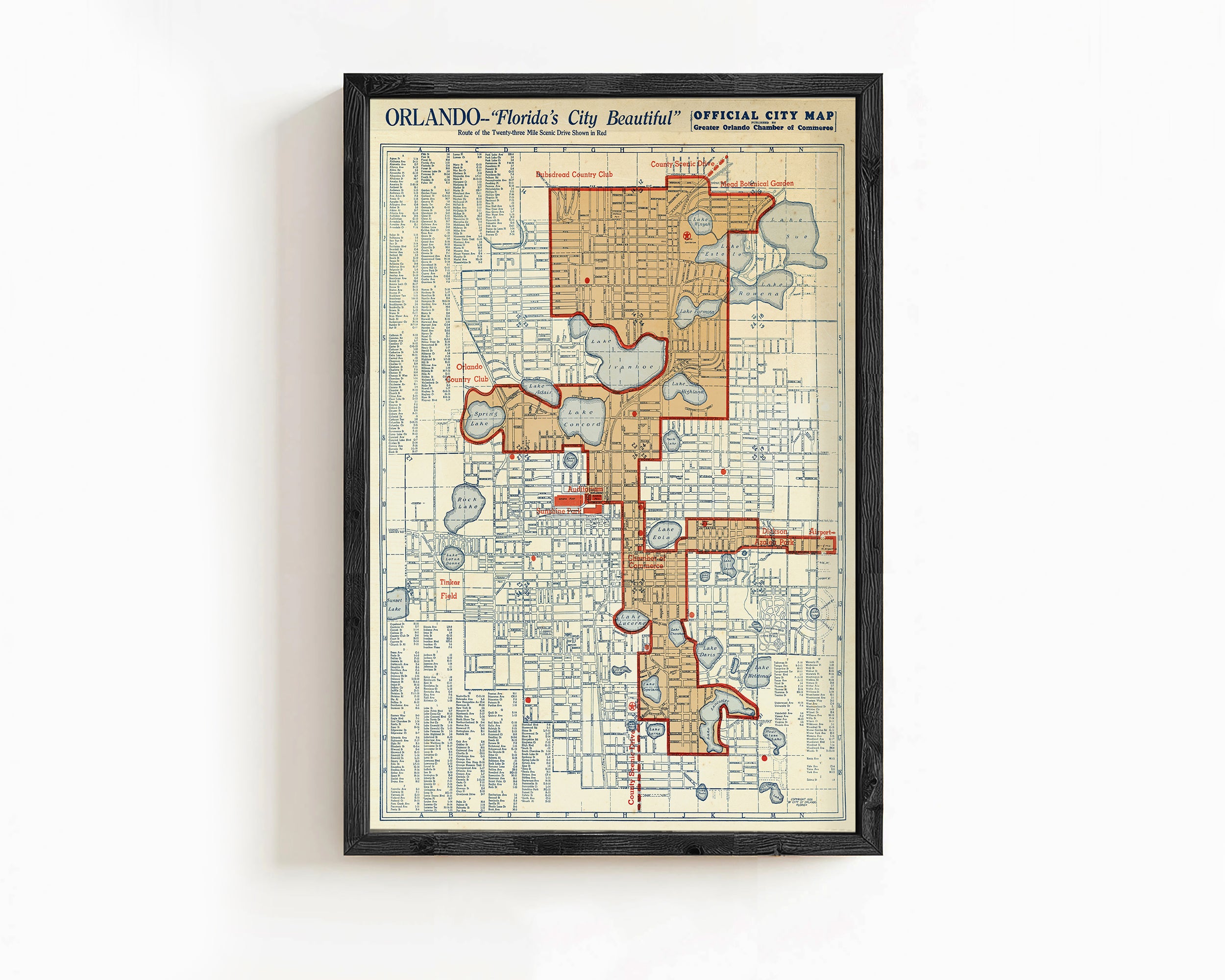 The image is a framed vintage map of Orlando, Florida, depicting the city's layout and streets.