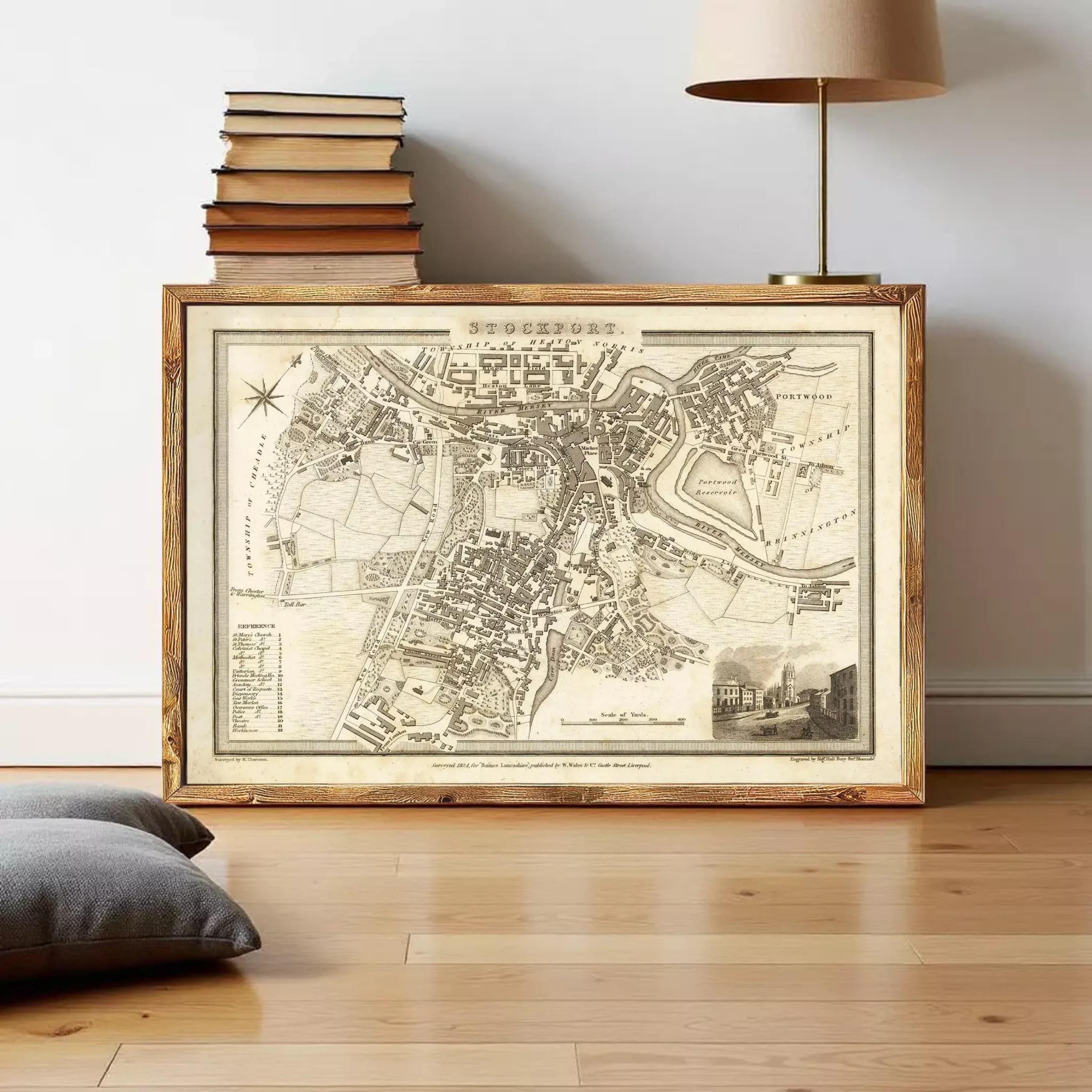 The image is a framed antique map of a city, likely from the 18th century, with detailed cartography and a wood-framed appearance.