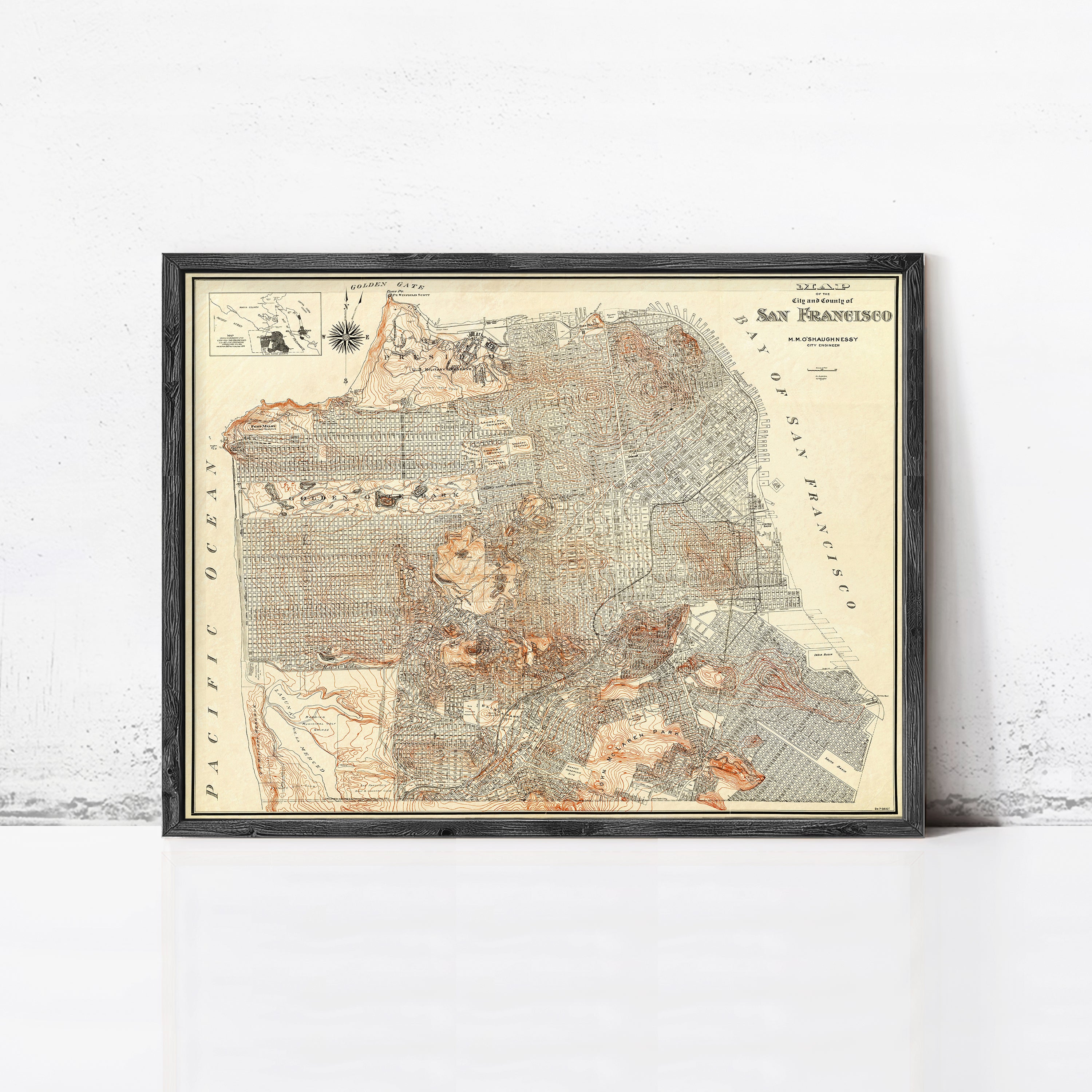 The image is a framed vintage map of San Francisco, California, depicting the city's streets and surrounding areas.