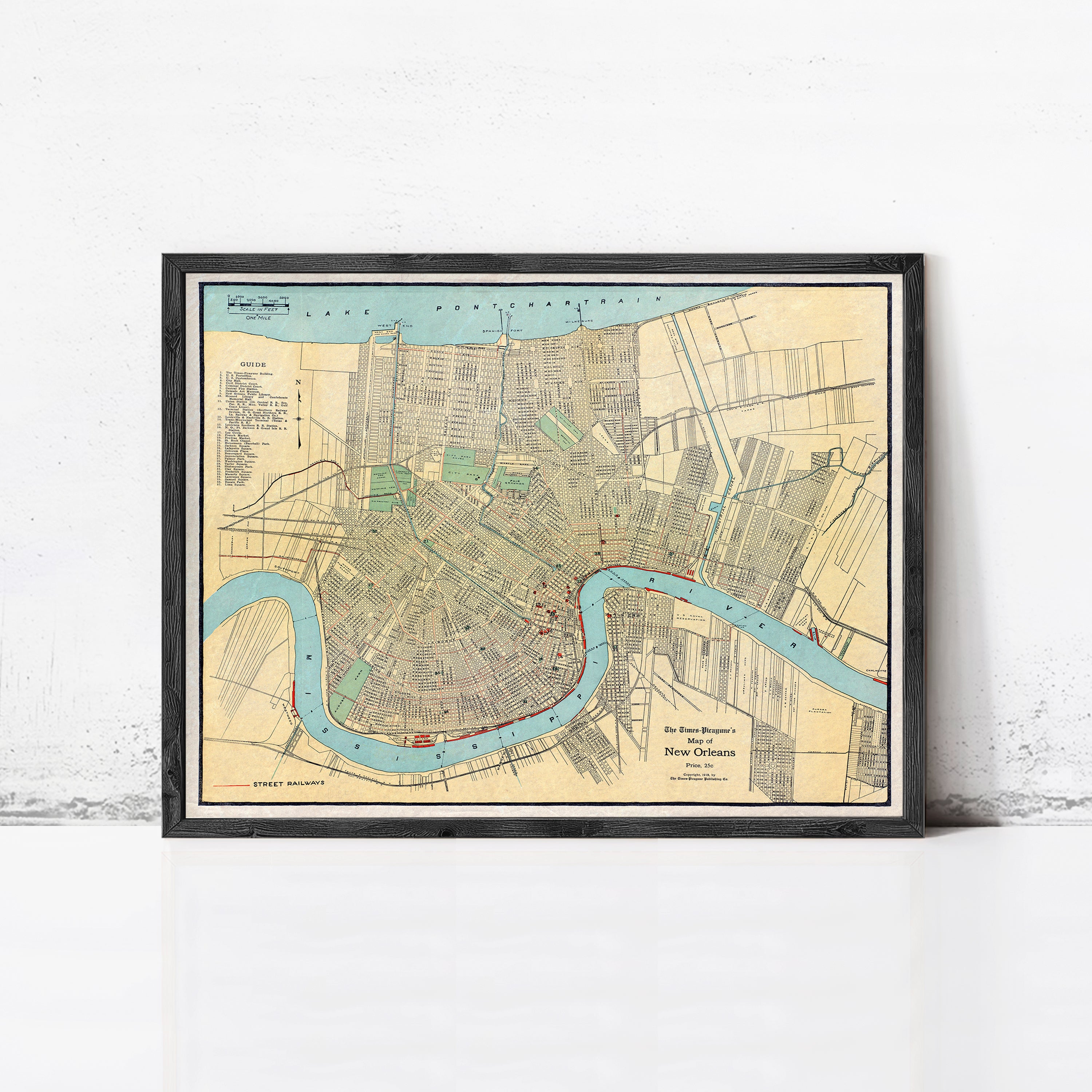 The image is a framed map of New Orleans, Louisiana, depicting the city's streets, landmarks, and waterways.