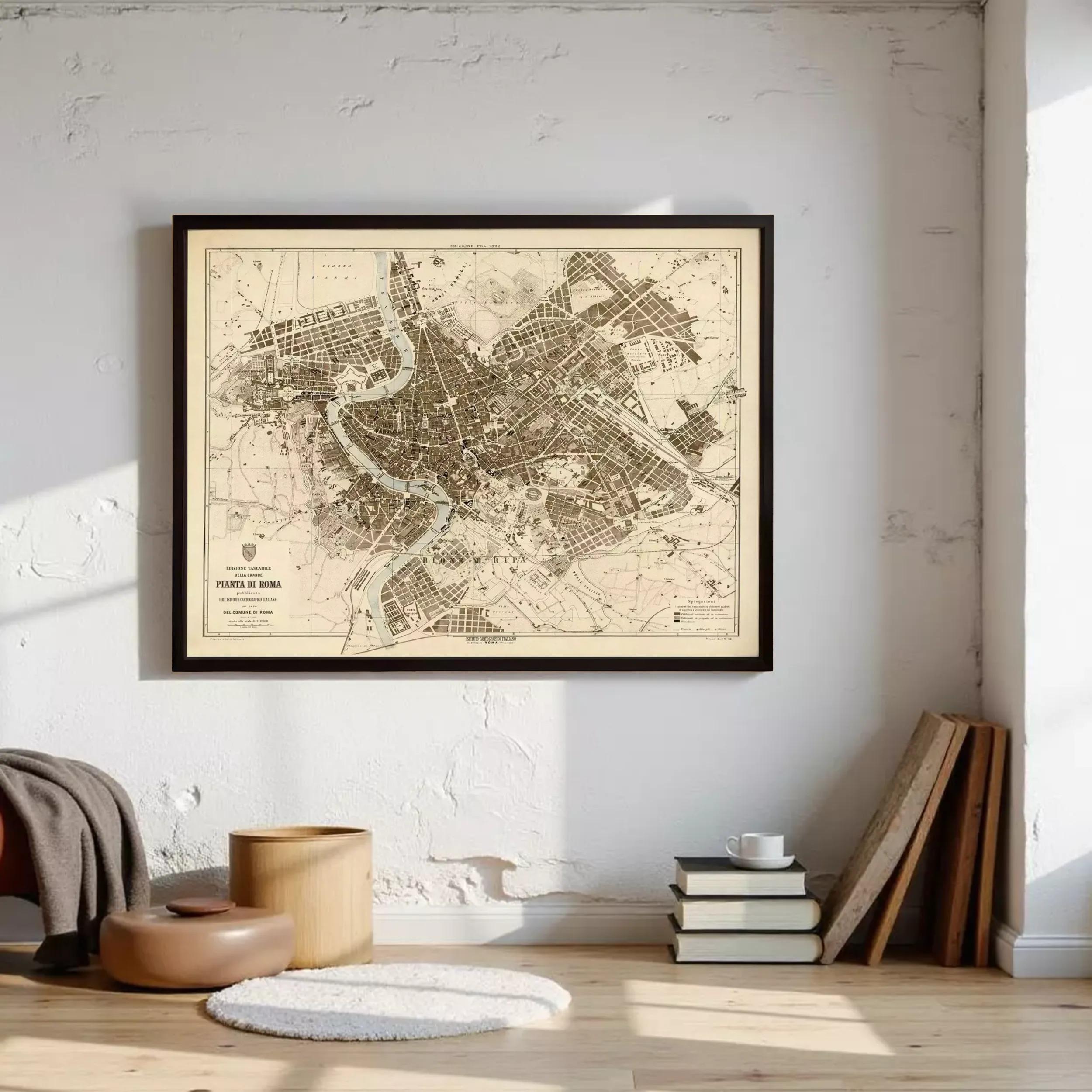 a framed map of a city hanging on a wall, with a stack of books and a wooden stool nearby.
