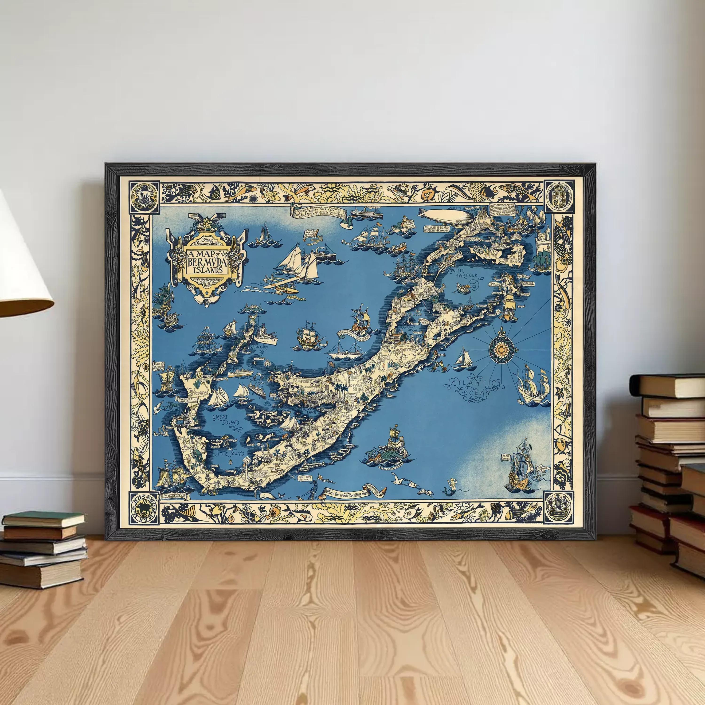 A framed vintage map of the Bahamas, featuring intricate illustrations and designs, is displayed on a wooden floor against a white wall.