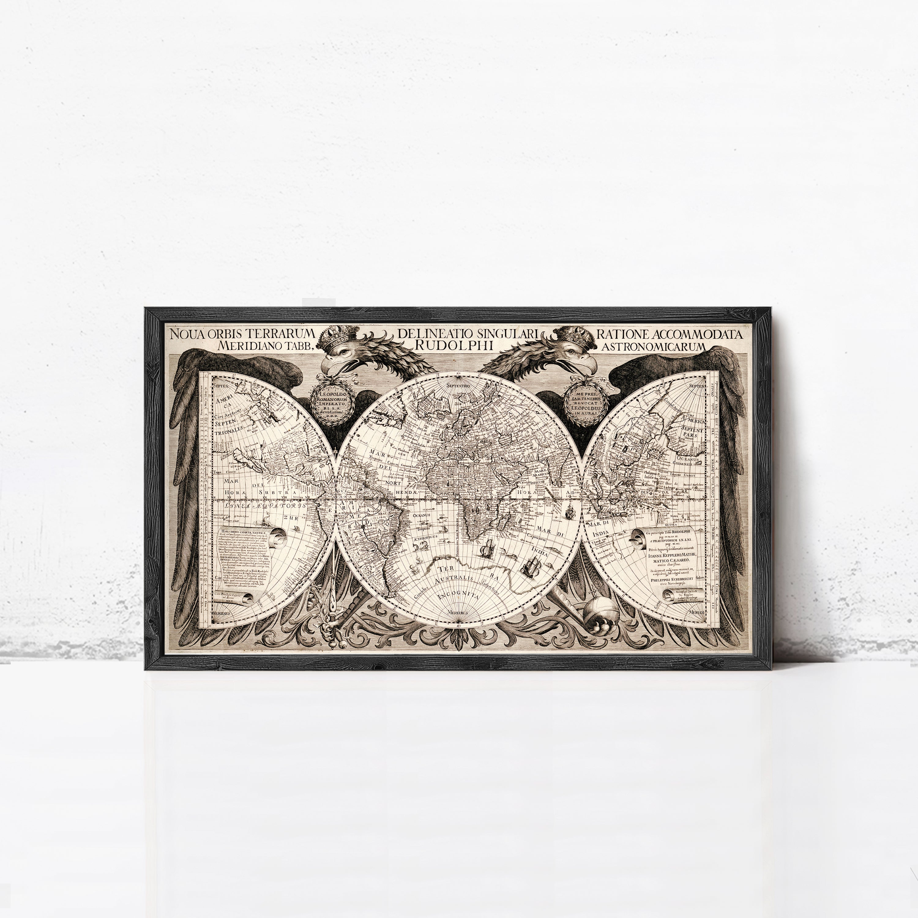 The image is a framed vintage map of the world, featuring intricate details and decorative elements.