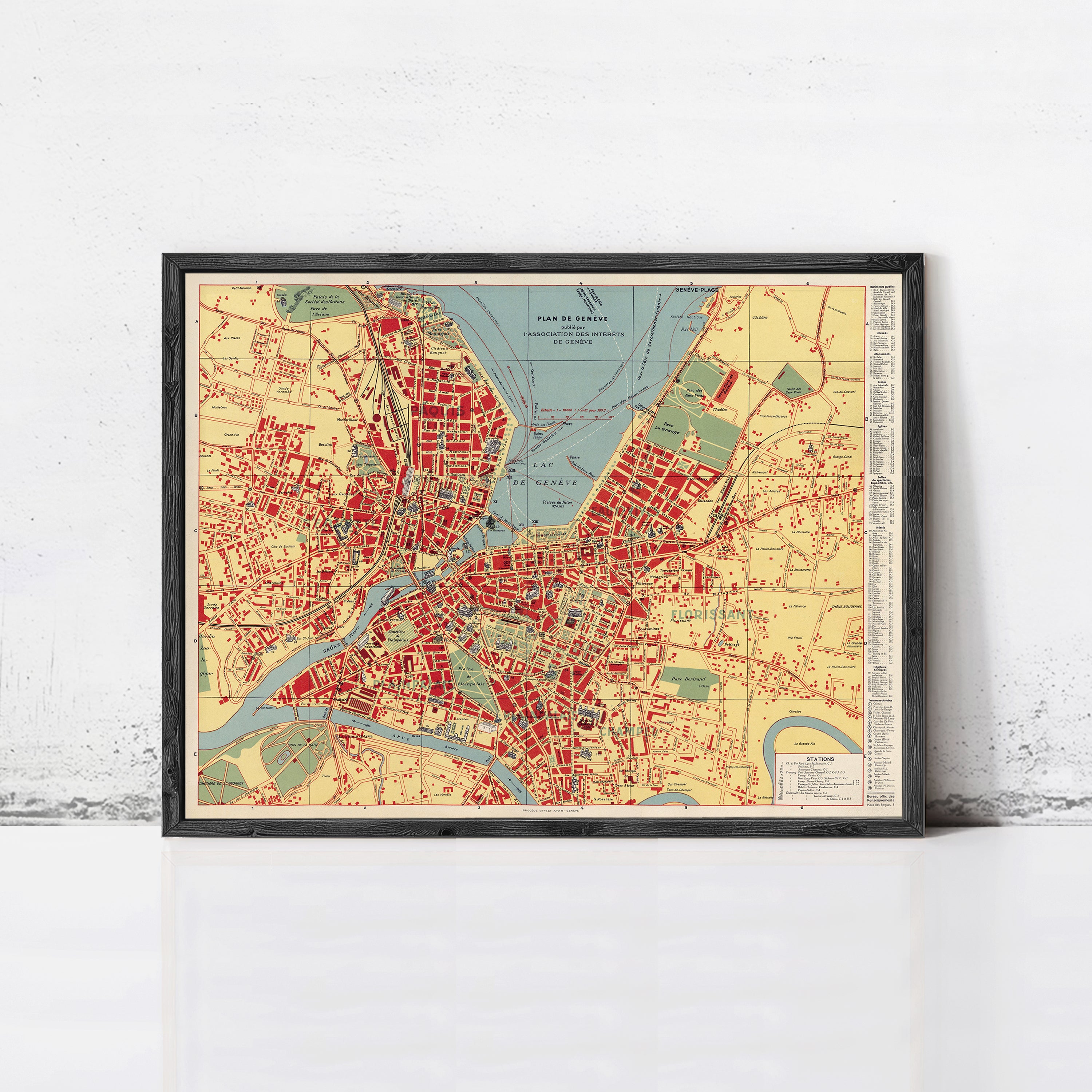 The image is a framed vintage map of a city, likely from the early 20th century, depicting the city's layout and surrounding areas.