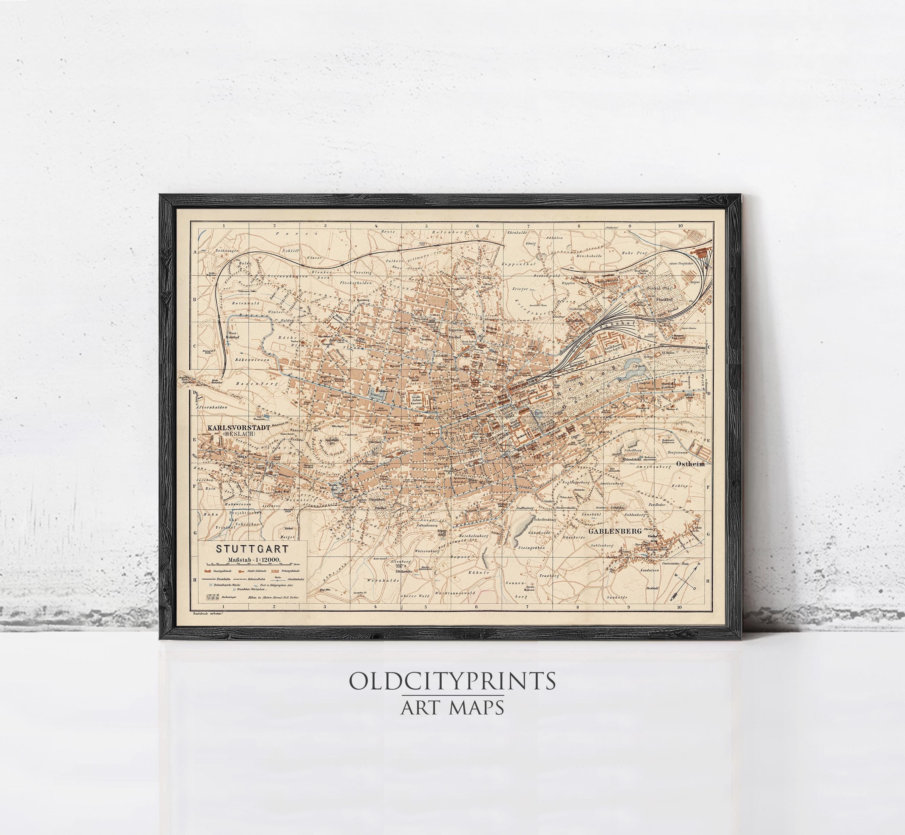 The image is a framed vintage map of Stuttgart, Germany, with a black border and beige color scheme.