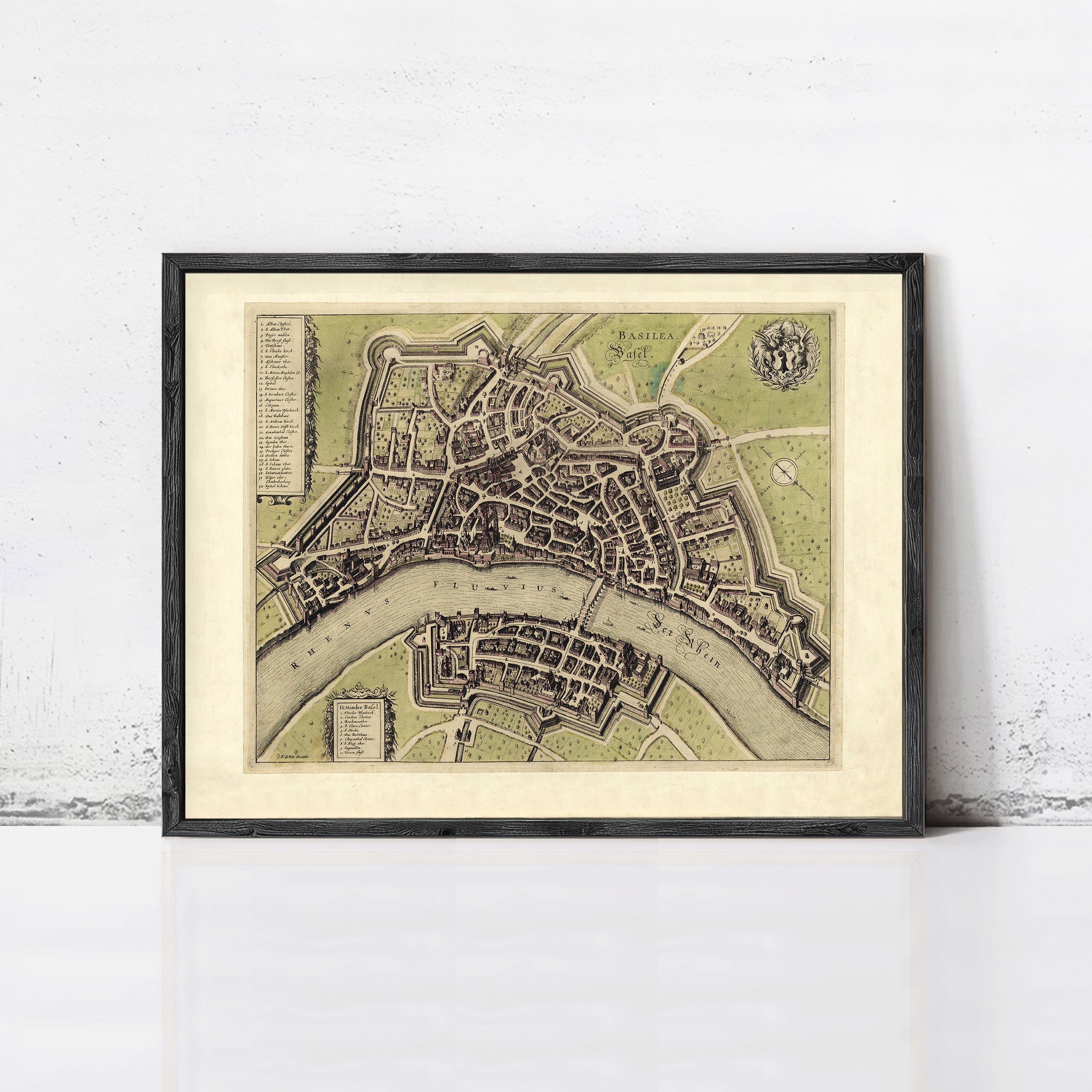 The image is a framed vintage map of a city, depicting a detailed layout of streets, buildings, and other urban features.