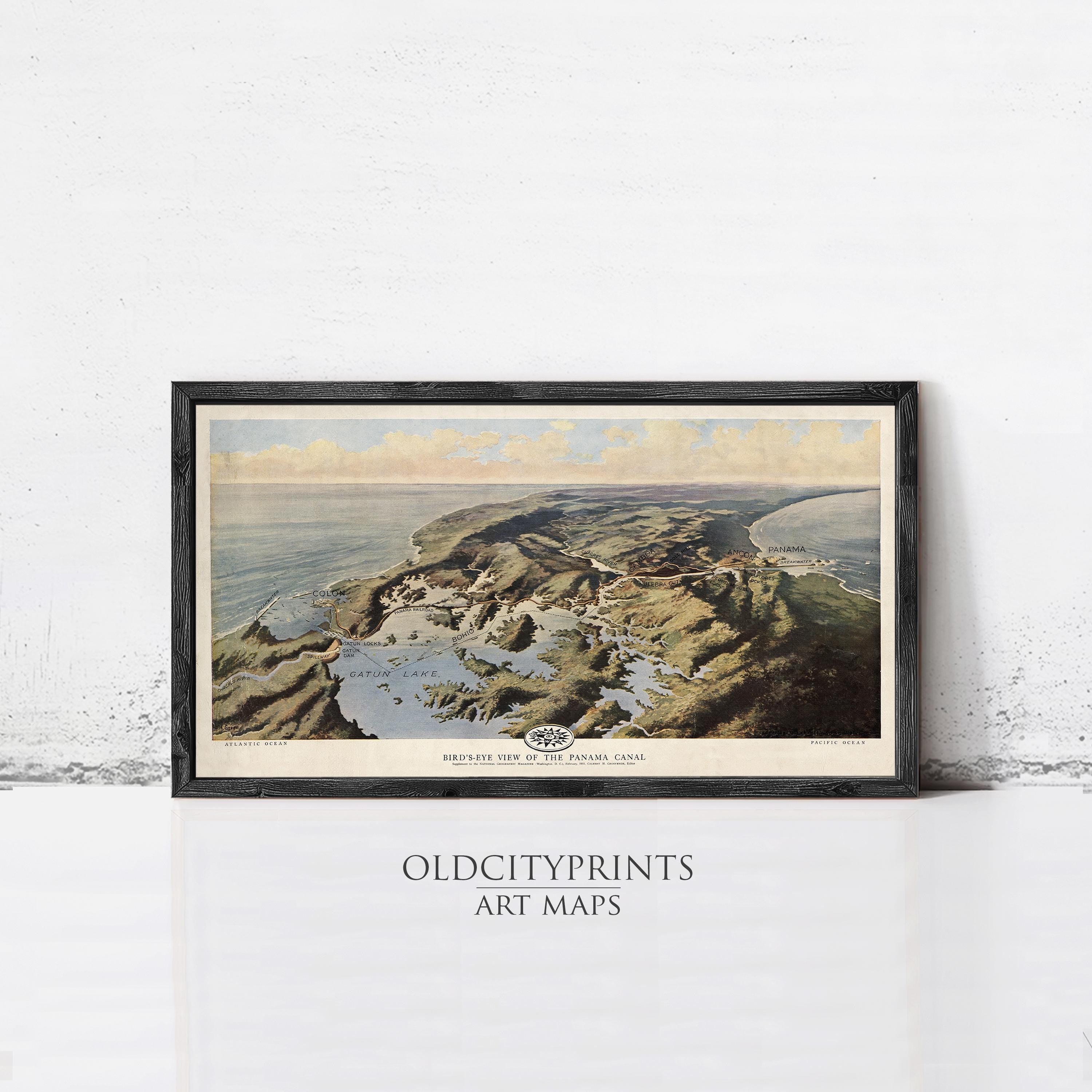The image is a framed art print depicting a coastal landscape with mountains, water, and clouds in the background.