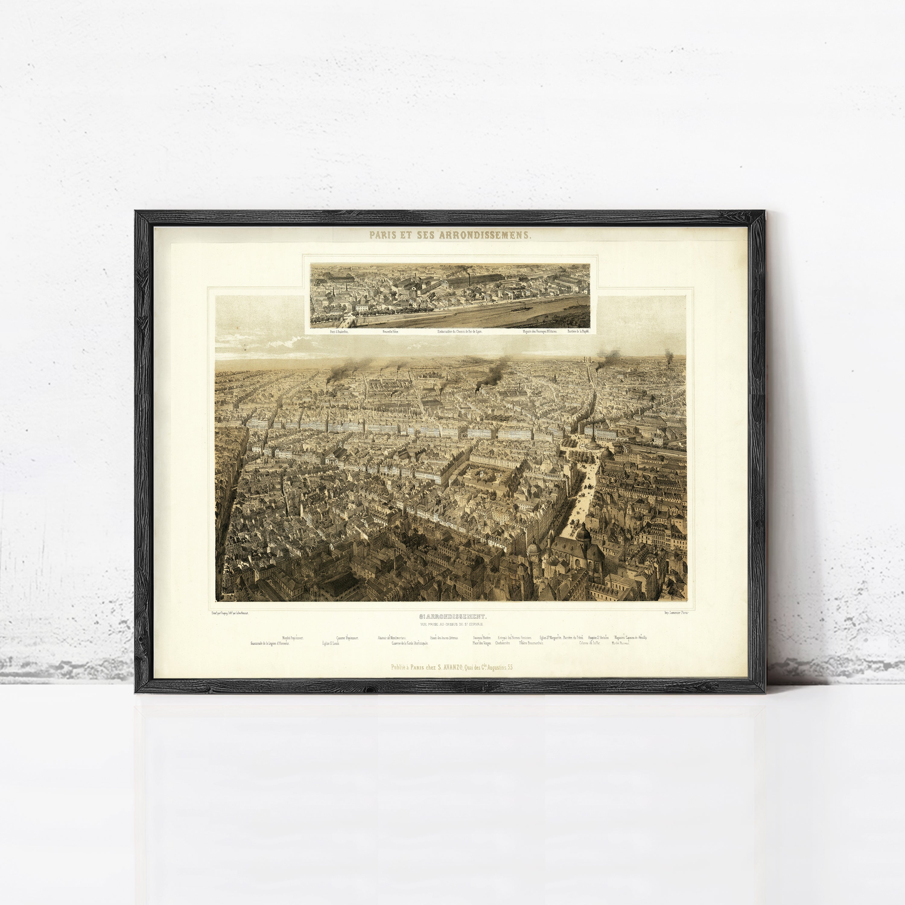 The image is a framed print of a large aerial view of a city, depicting a densely populated urban landscape with numerous buildings and streets.