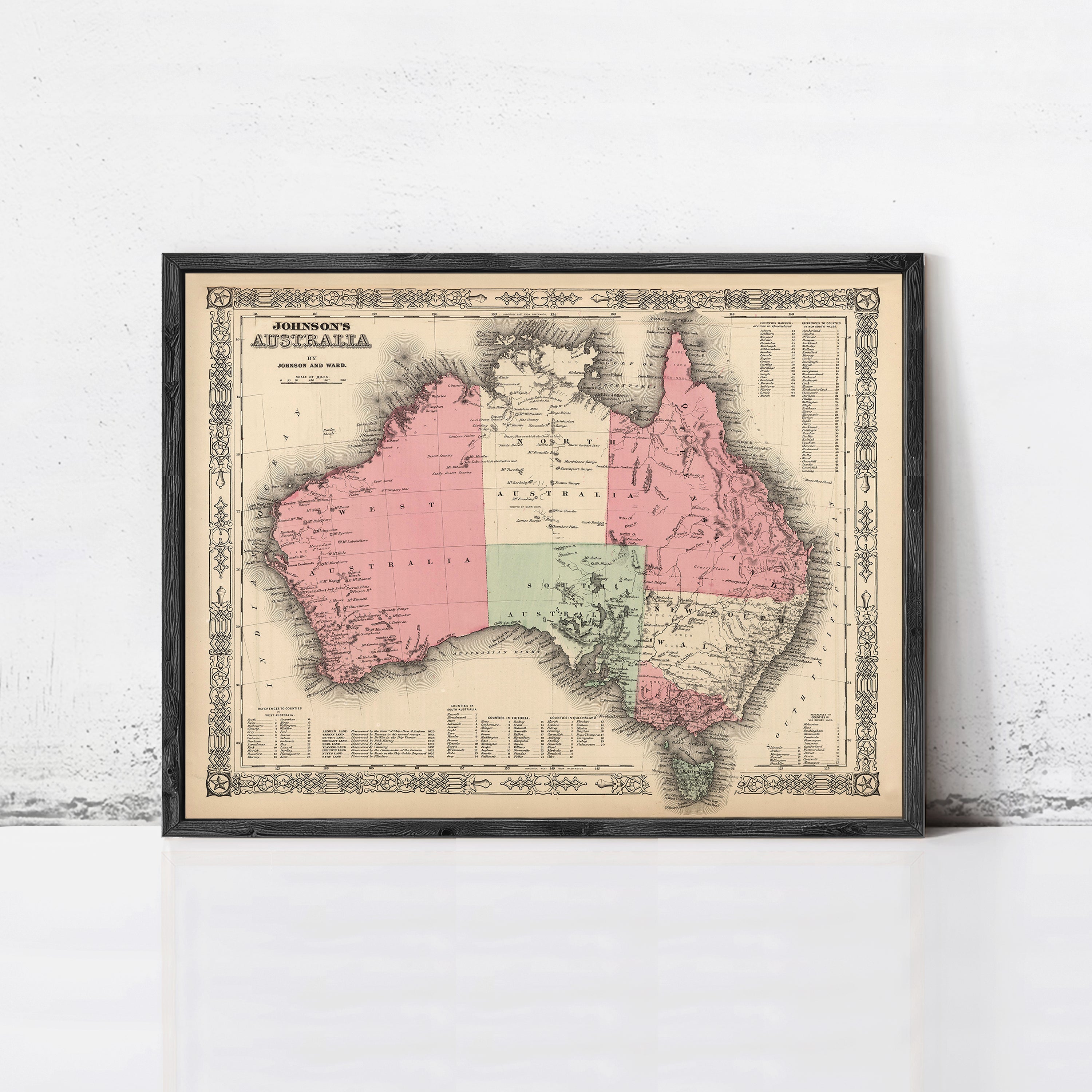 The image is a framed vintage map of Australia, depicting the country in a detailed and intricate manner.