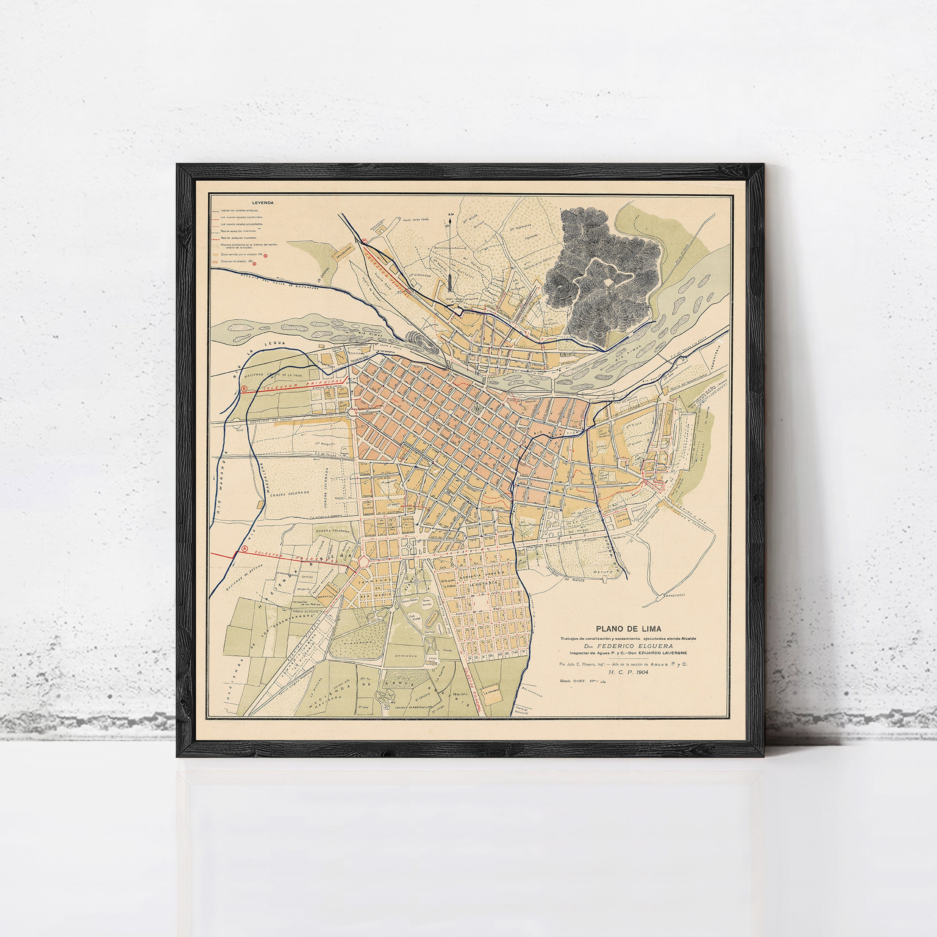 The image is a framed map of a city, depicting various streets, landmarks, and geographical features.