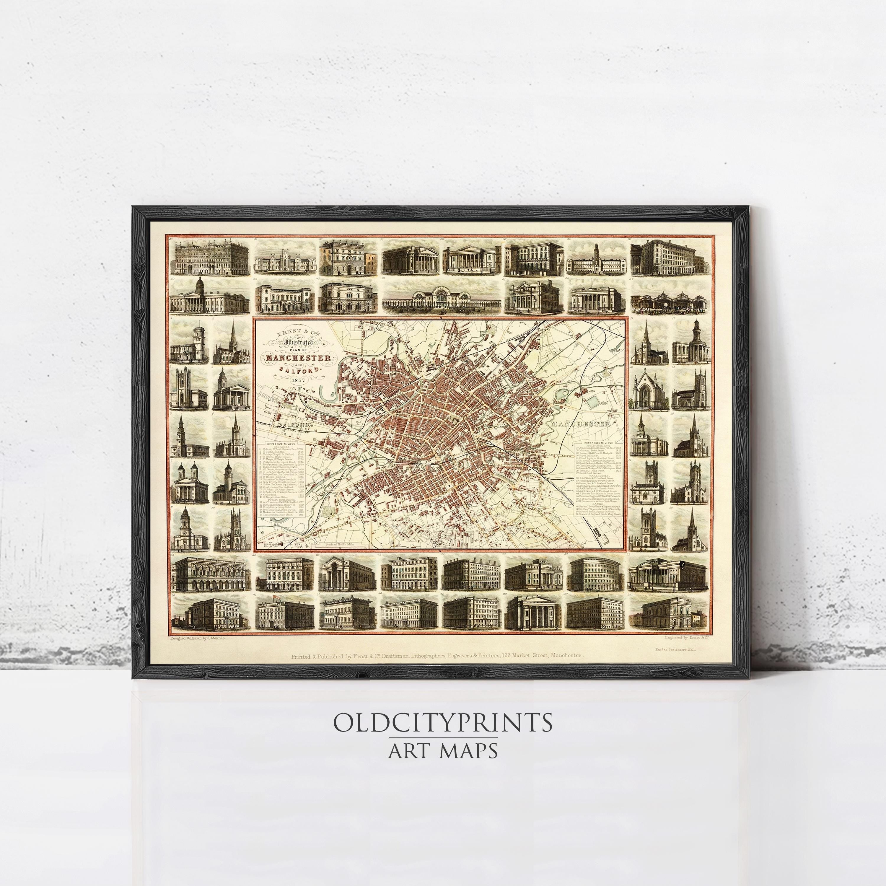 The image is a framed art print depicting a detailed map of Manchester, London, with various buildings and landmarks throughout the city.
