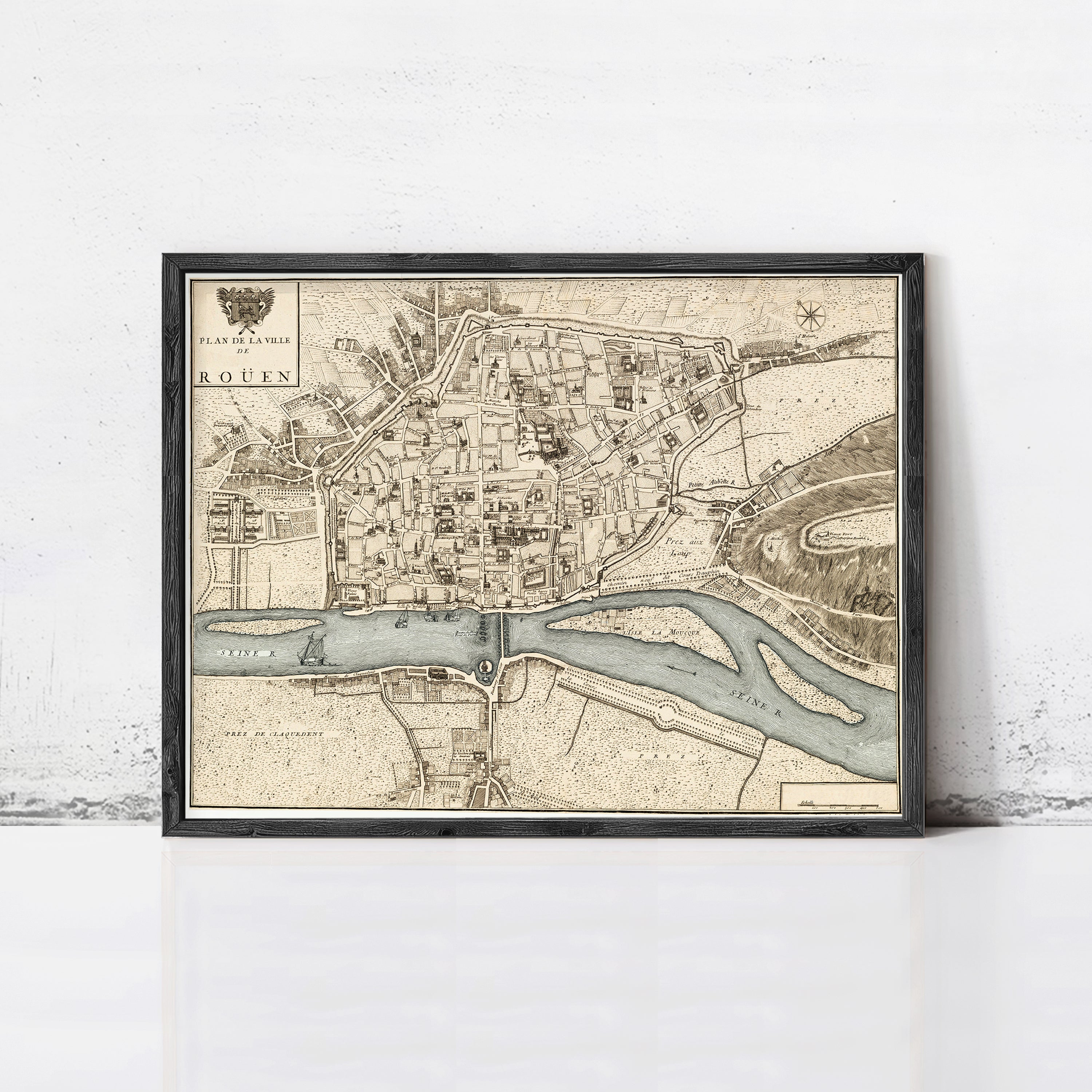 The image is a framed map of the city of Rouen, France, depicting the city's layout and surrounding areas.