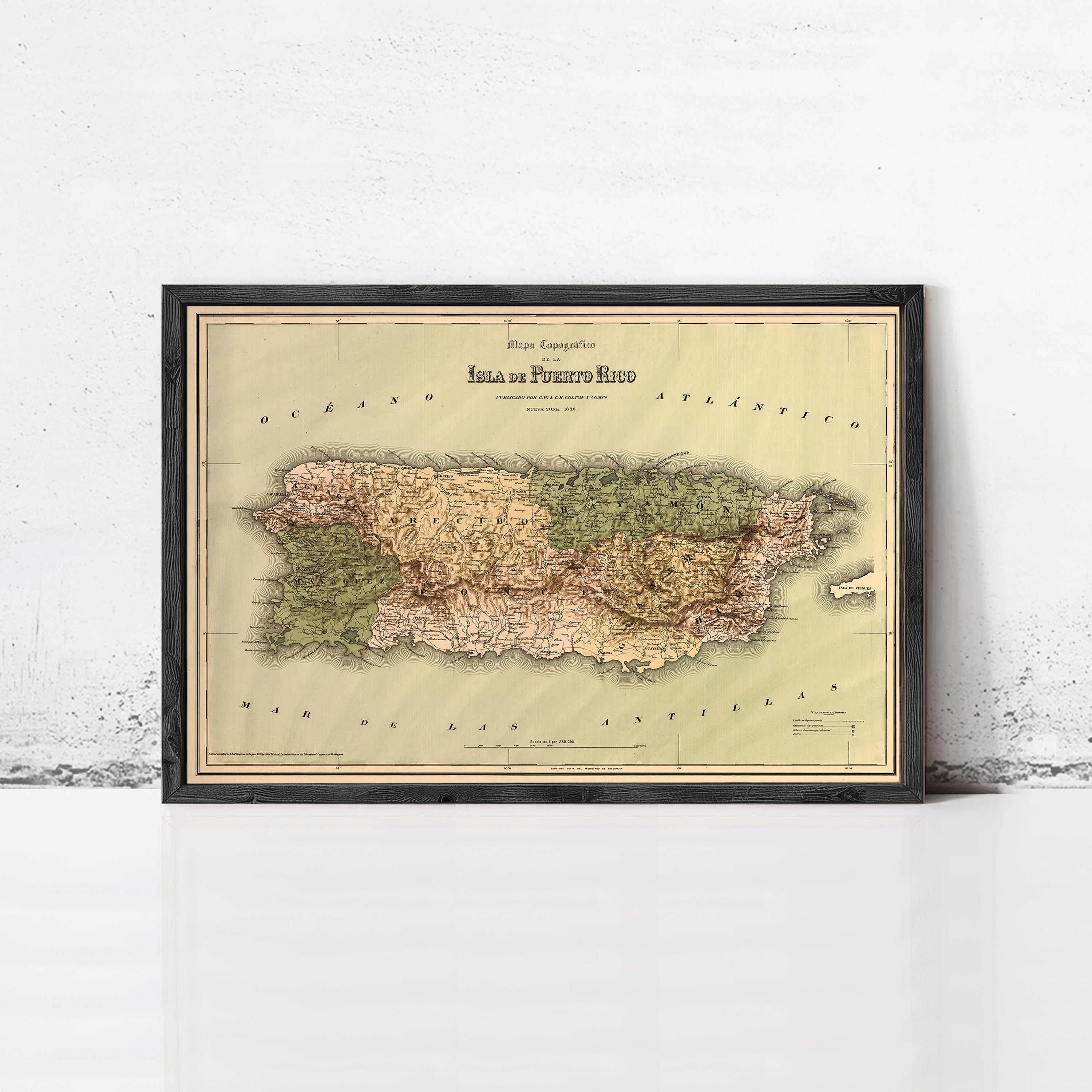 The image is a framed vintage map of Puerto Rico, depicting the island's geographical layout and surrounding areas.