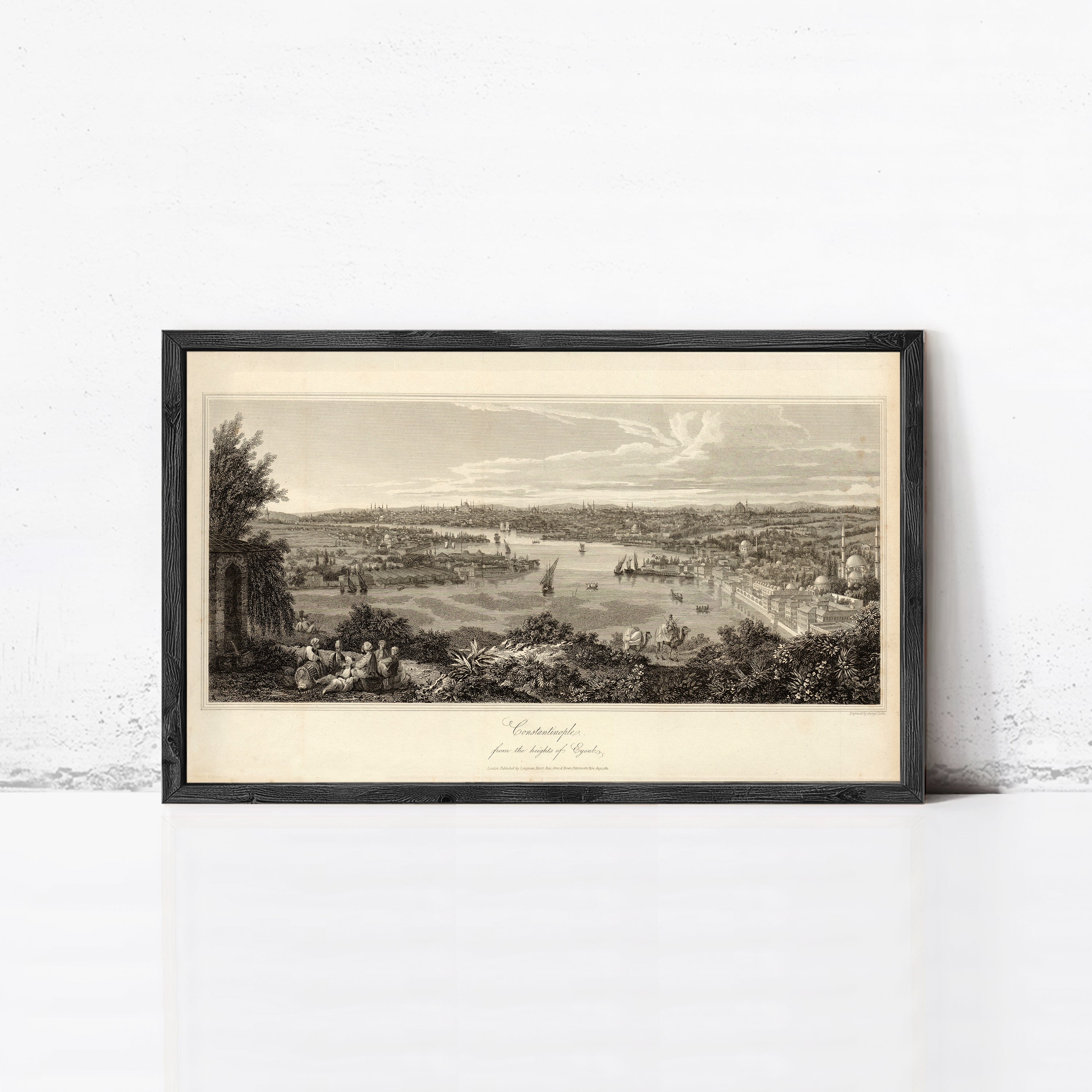 The image is a framed print depicting a cityscape with boats in the water, set against a cloudy sky.