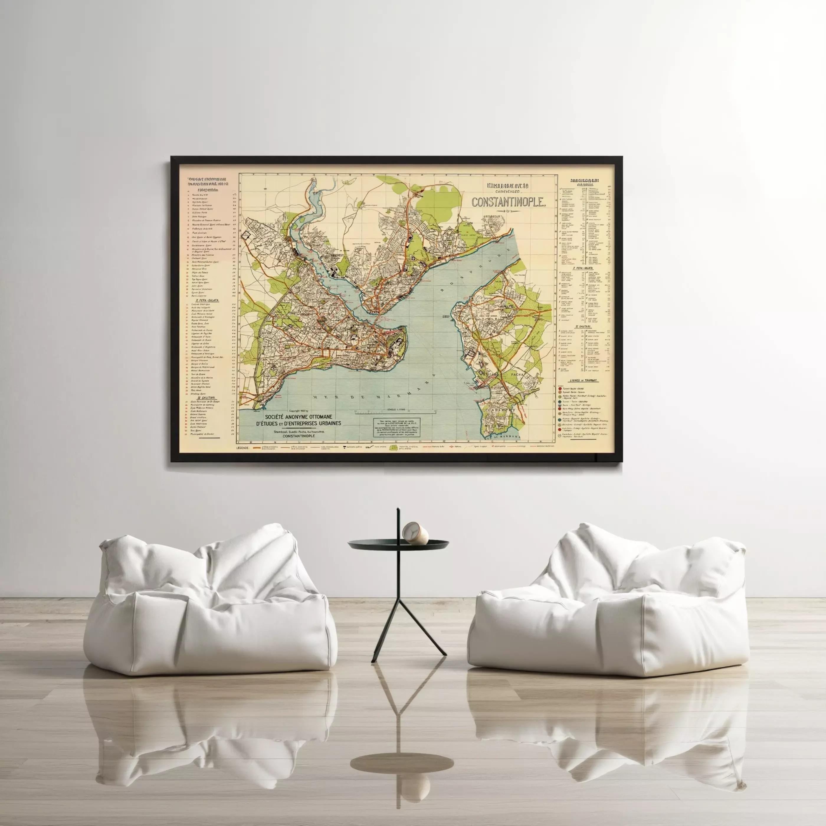 a large framed map of the city of Baltimore, Maryland, hanging on a white wall above a small table with two white bean bag chairs.