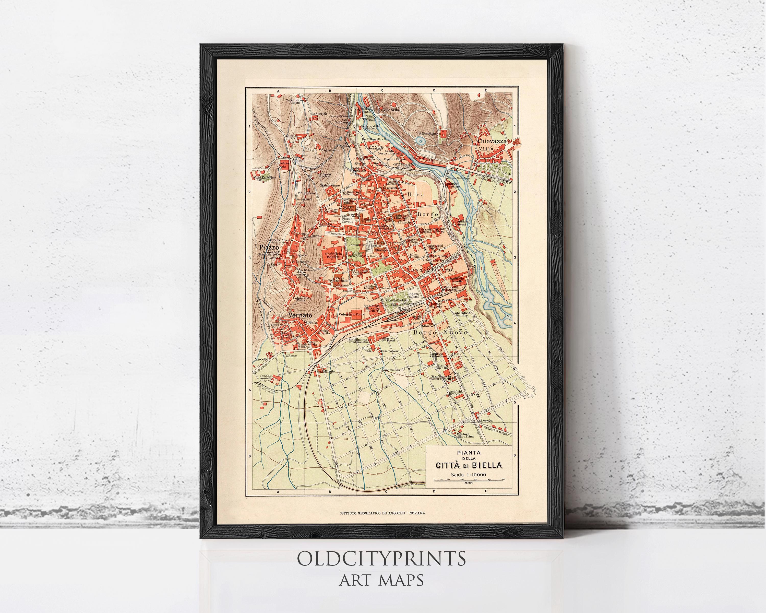 The image is a framed vintage map of a city, depicting the layout and surrounding areas.