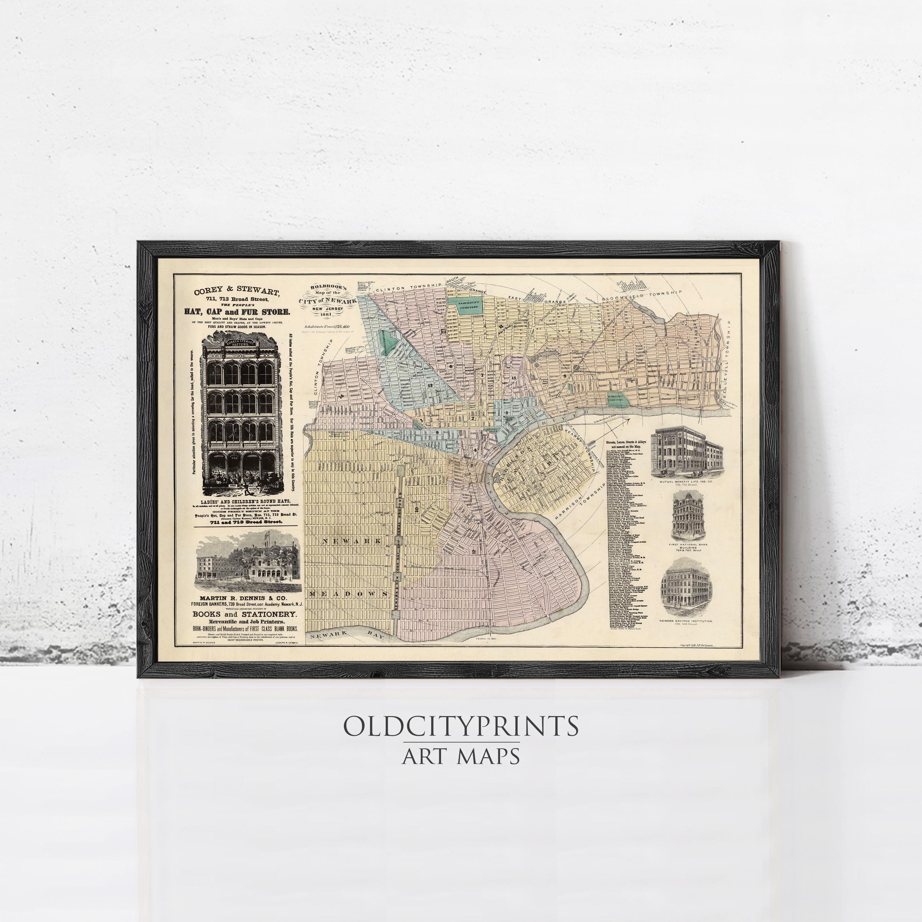 The image is a framed vintage map of a city, likely from the early 20th century, with various buildings and streets depicted.