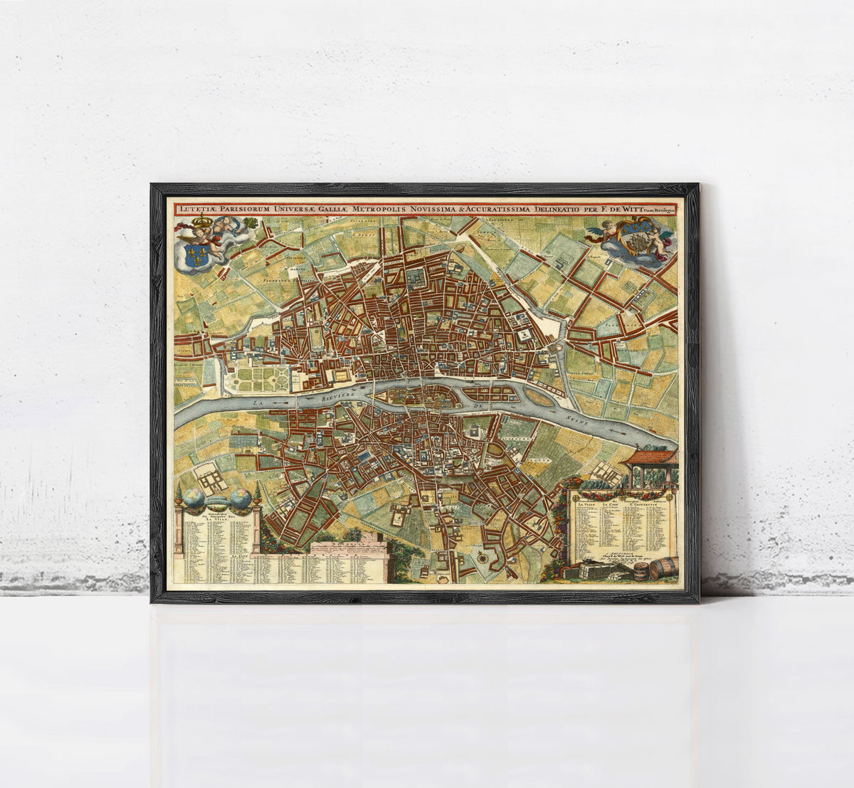 The image is a framed vintage map of a city, likely Paris, with detailed illustrations and labels.