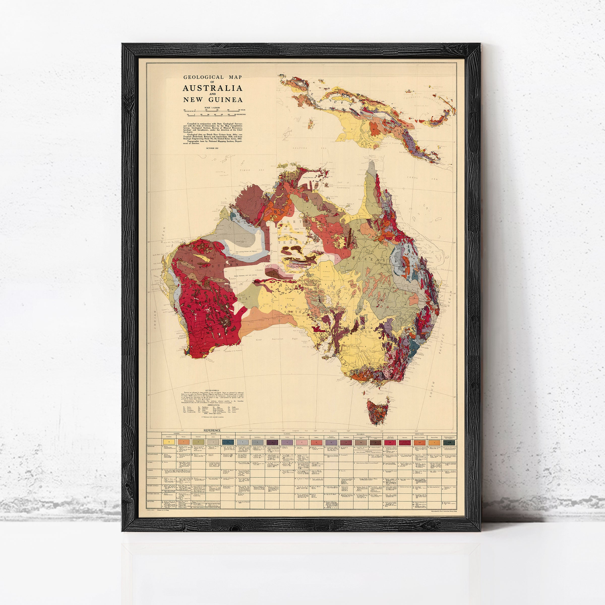 The image is a framed geological map of Australia and New Guinea, depicting the region's geological features and topography.