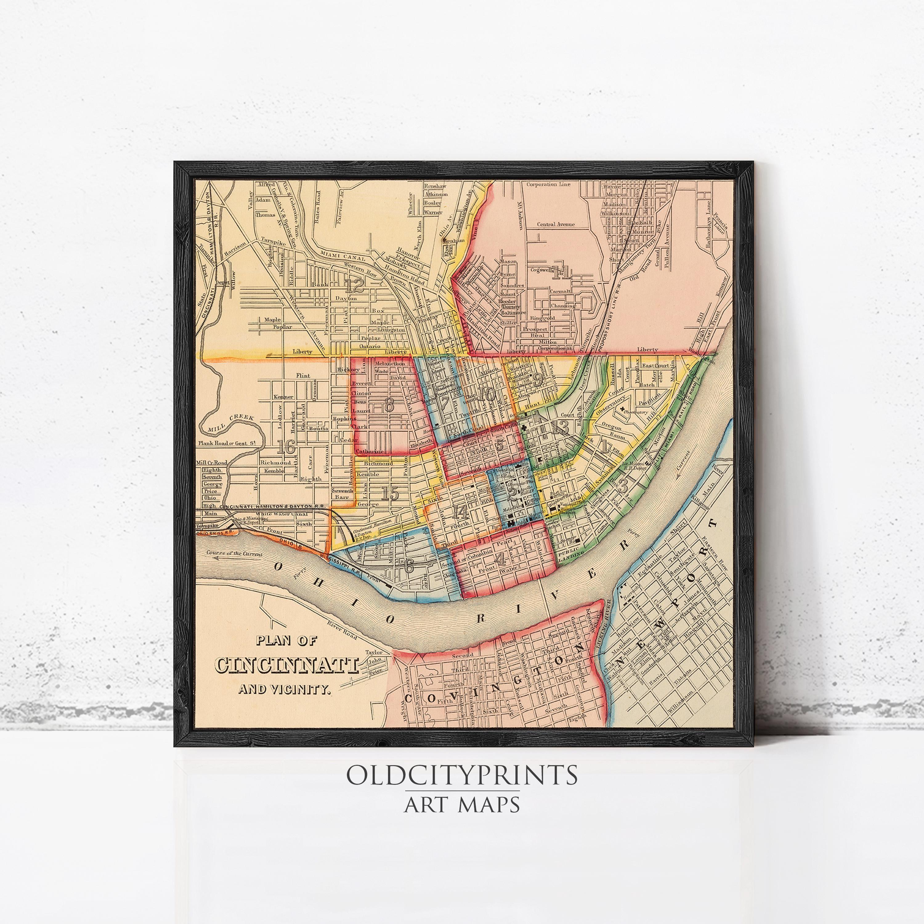 The image is a framed vintage map of Cincinnati, Ohio, depicting the city's streets and neighborhoods in a detailed and colorful manner.