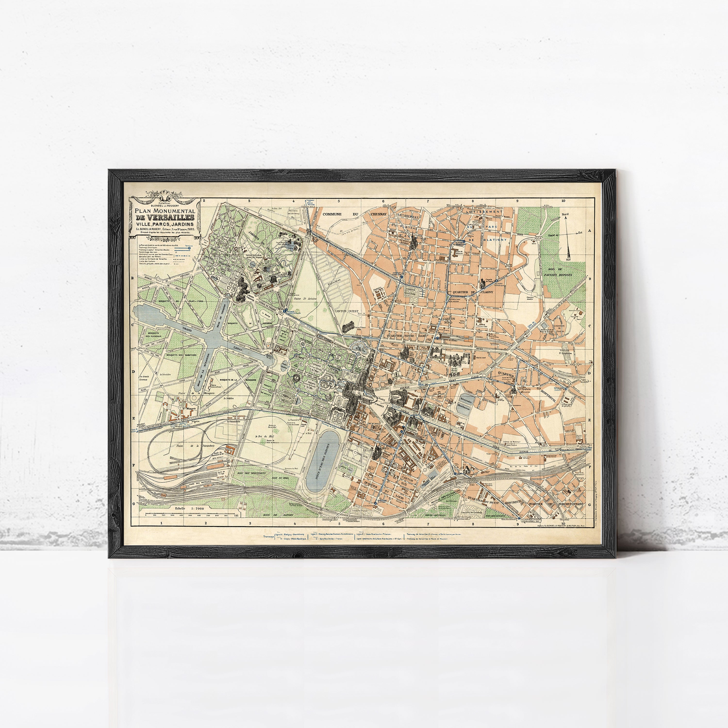 The image is a framed vintage map of a city, depicting various landmarks and streets in a detailed manner.