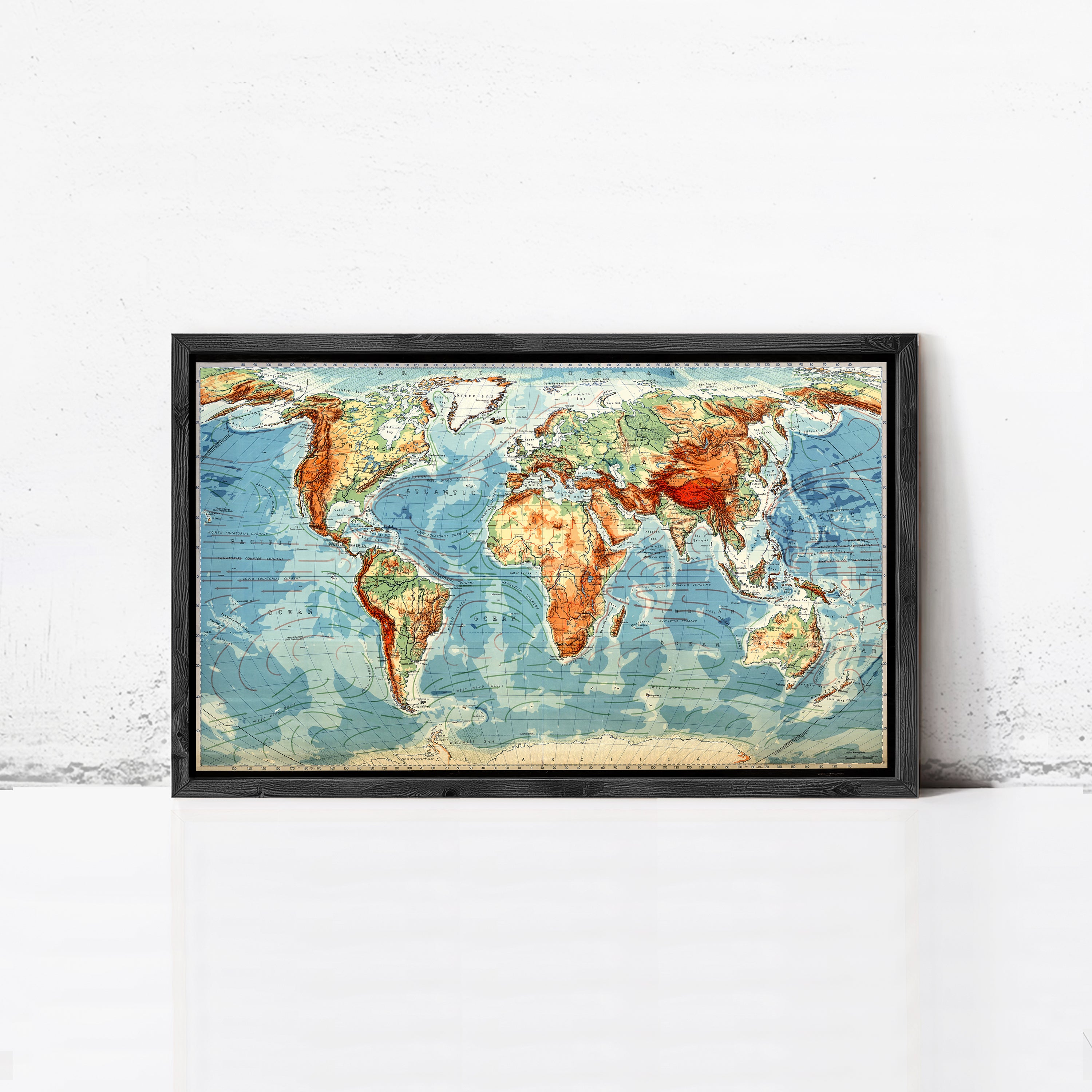The image is a framed vintage world map with a colorful and detailed depiction of the continents and oceans.