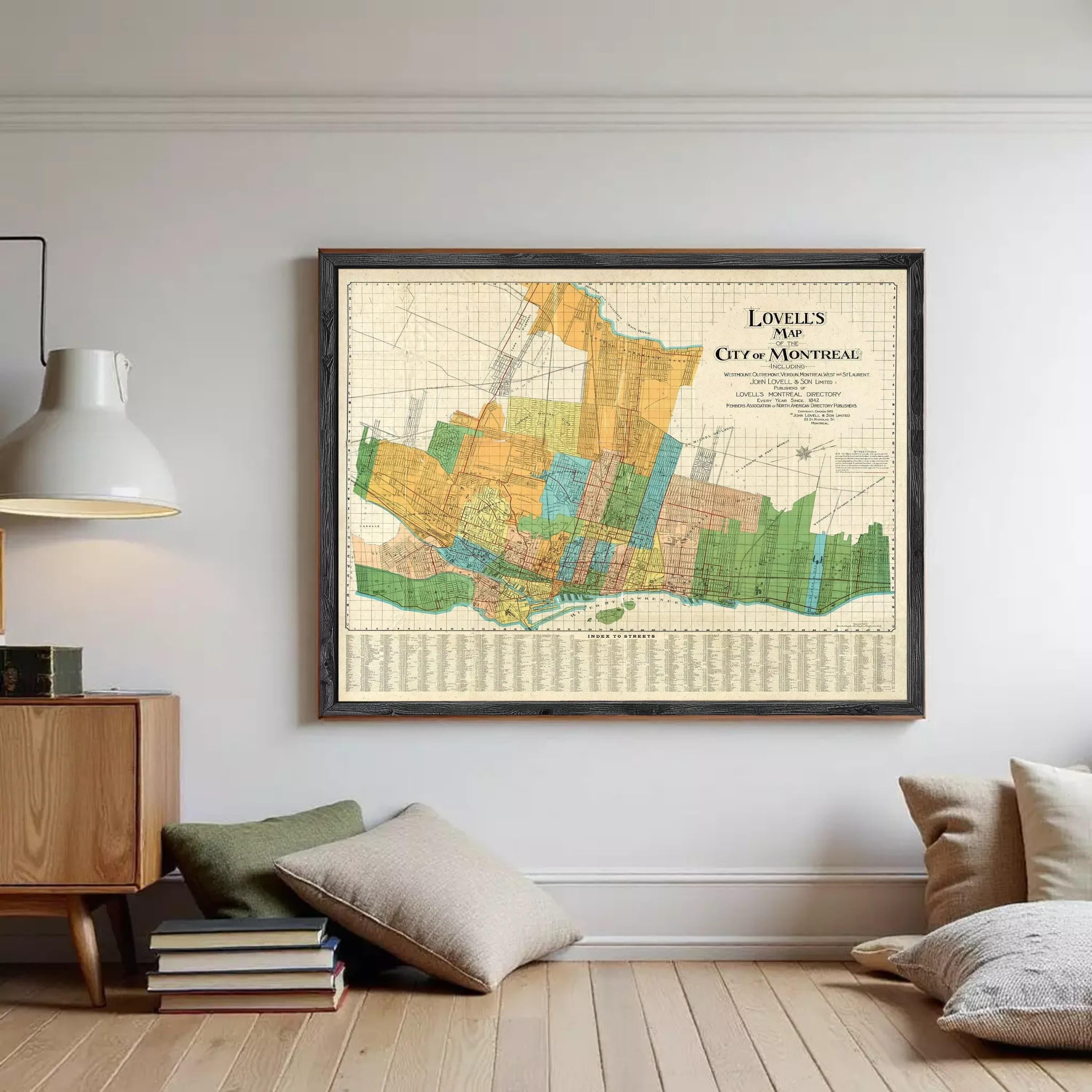 The image is a framed map of the city of Montreal, Canada, with various colored sections representing different neighborhoods and areas within the city.