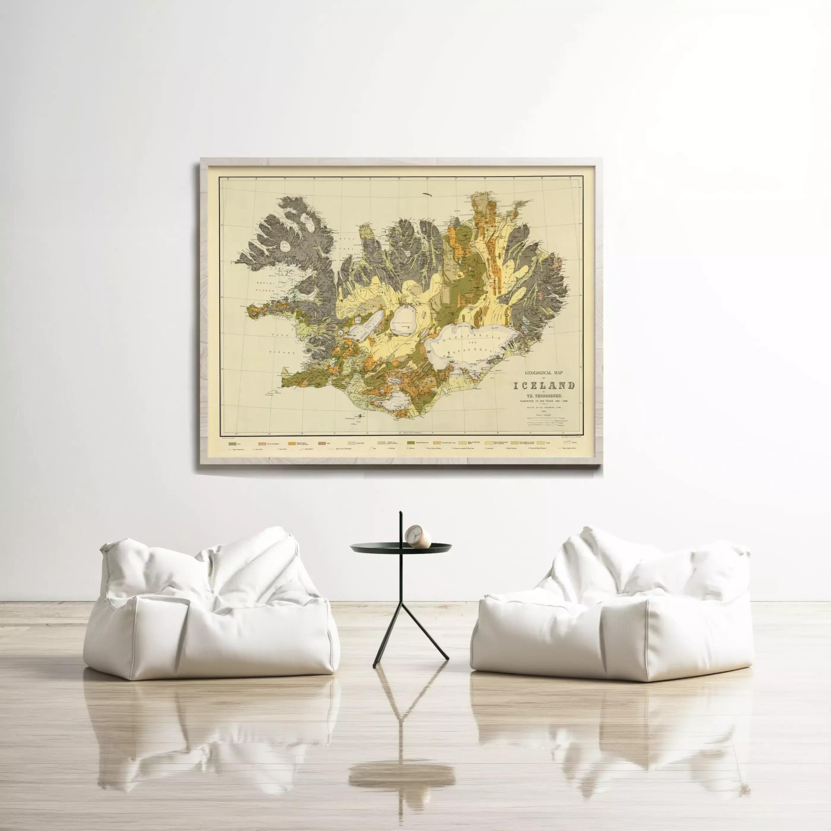 a large map of Iceland hanging on a wall, with two white bean bag chairs positioned in front of it.
