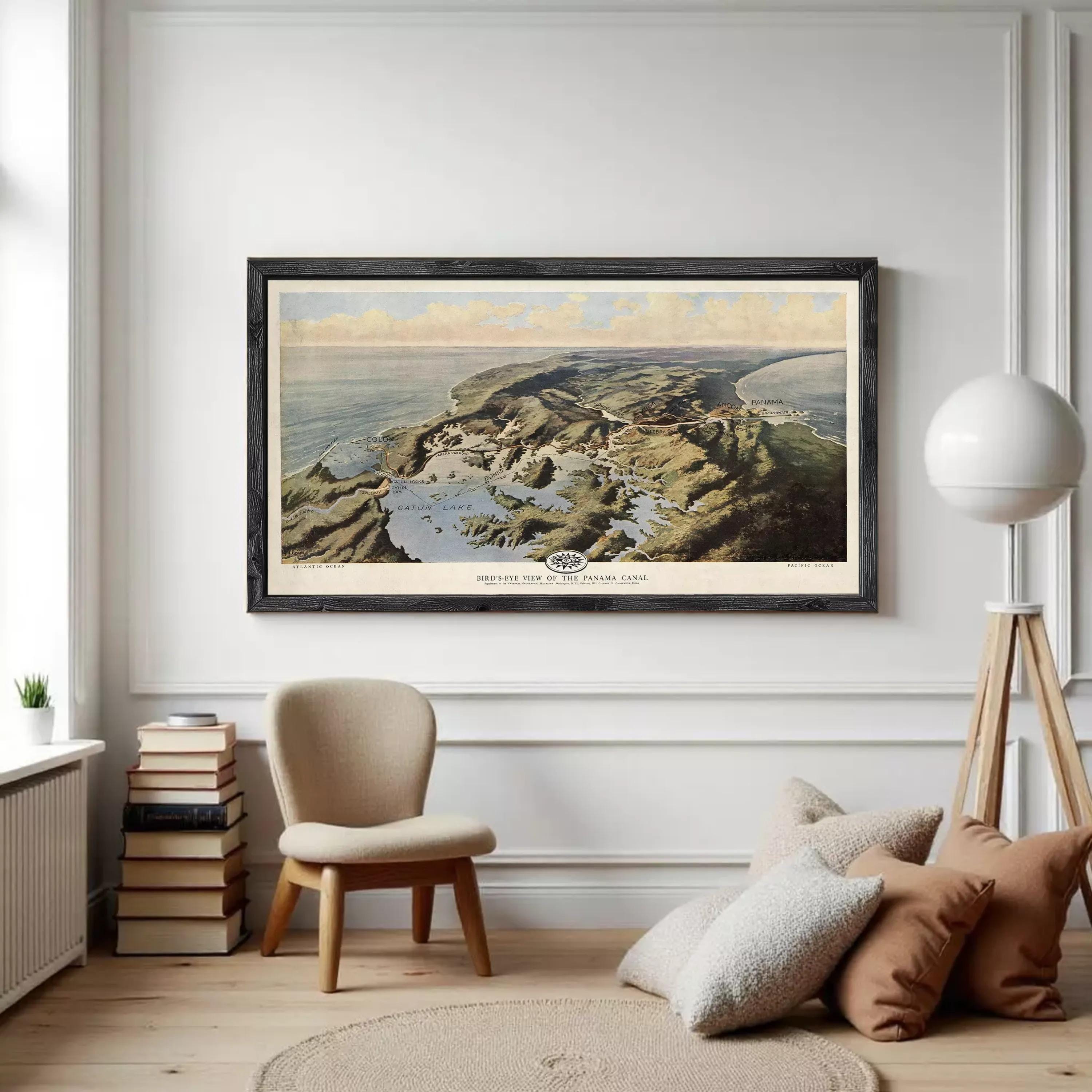 The image is a framed painting depicting a coastal landscape with mountains, water, and clouds in the background.
