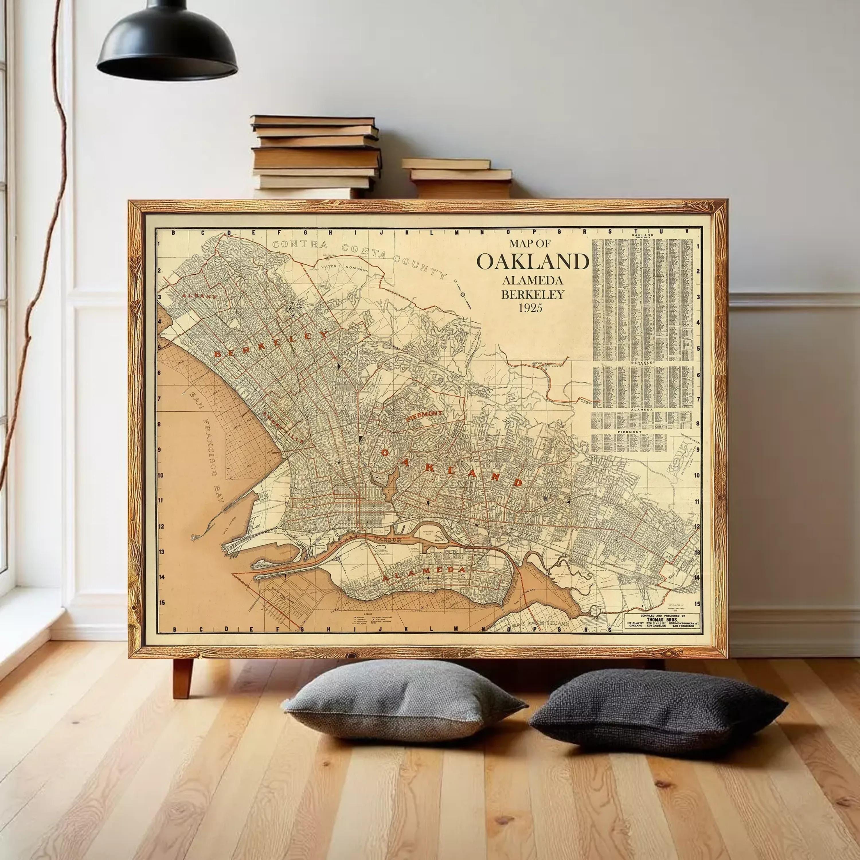 The image is a framed vintage map of Oakland, California, showing the city's streets and surrounding areas.