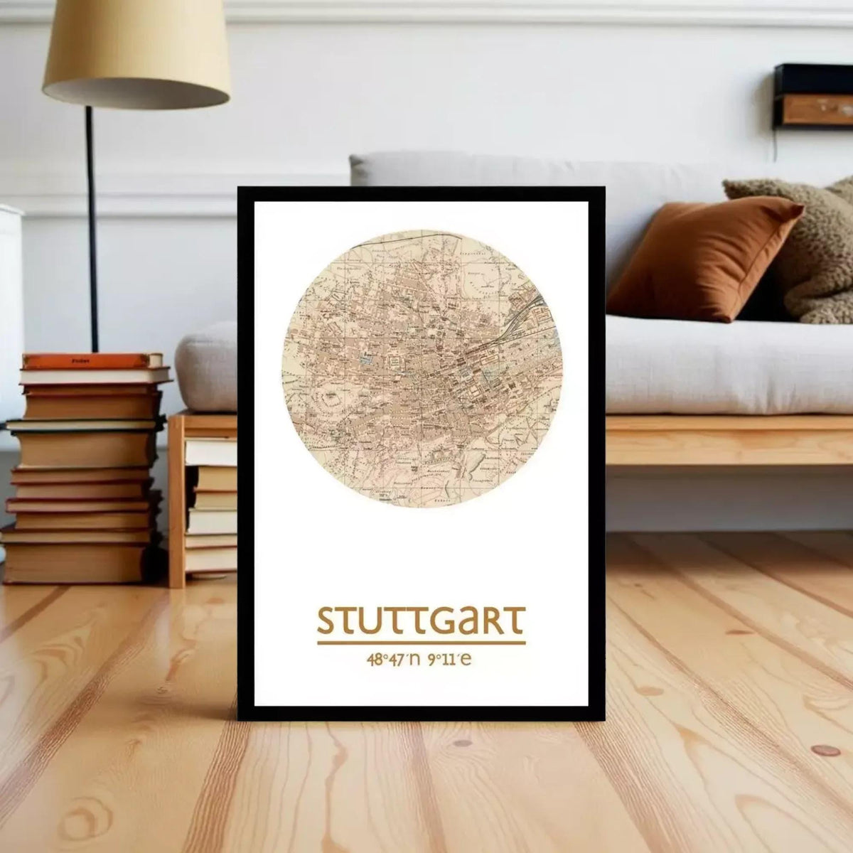 A framed map of Stuttgart, Germany, with the text "STUTTGART" and a coordinate system, placed on a wooden floor in a living room setting.