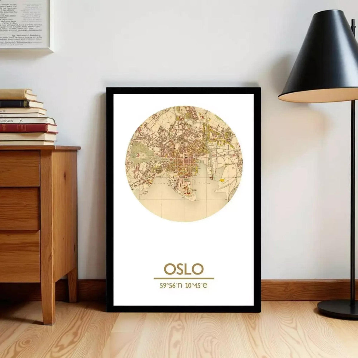 A framed map of Oslo, Norway, with the text "OSLO" printed on it, is displayed on a wall next to a wooden dresser and a lamp.