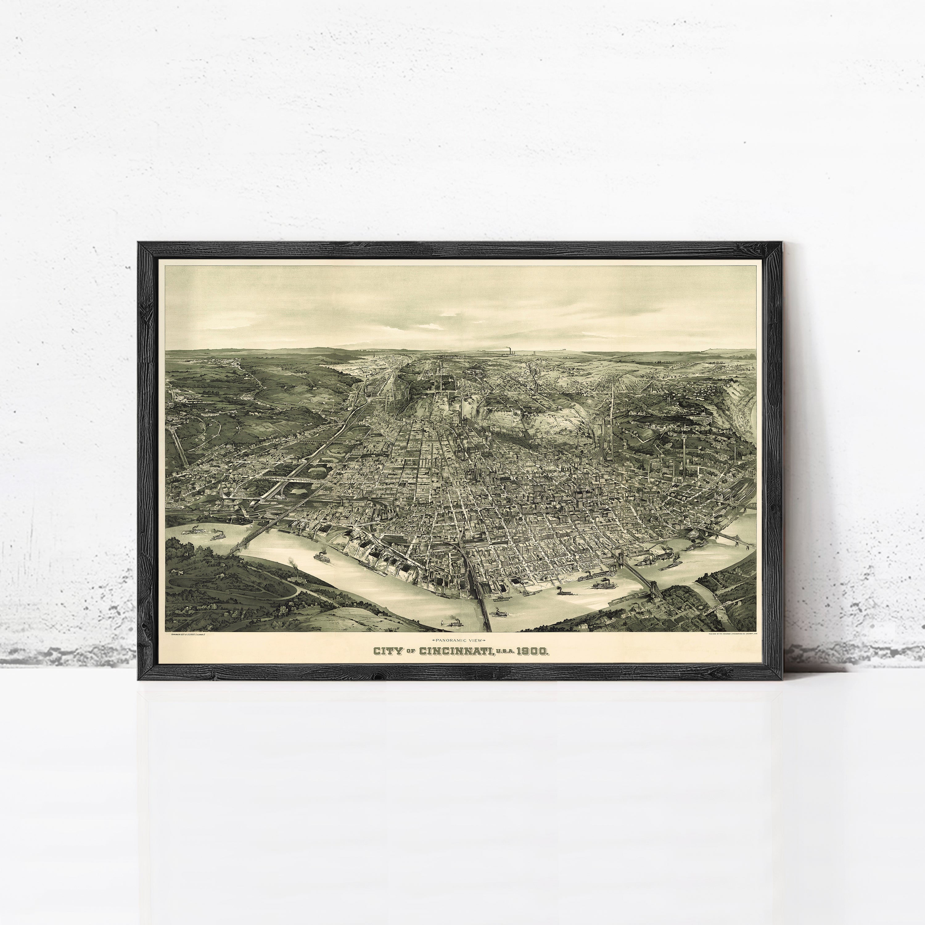 The image is a framed vintage map of Cincinnati, Ohio, depicting the city's layout and surrounding areas in a detailed and intricate manner.