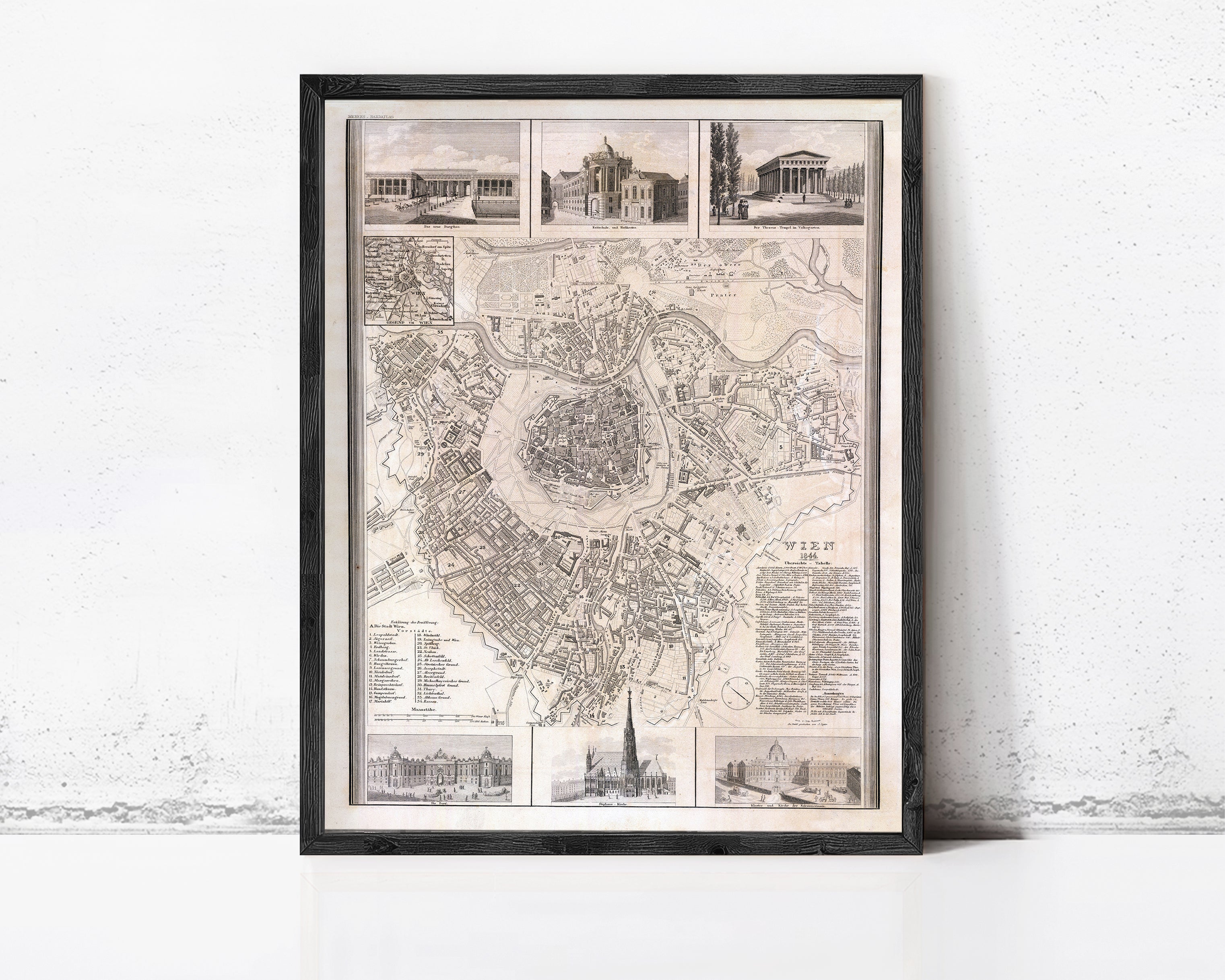 The image is a framed historical map of a city, depicting various landmarks and buildings.