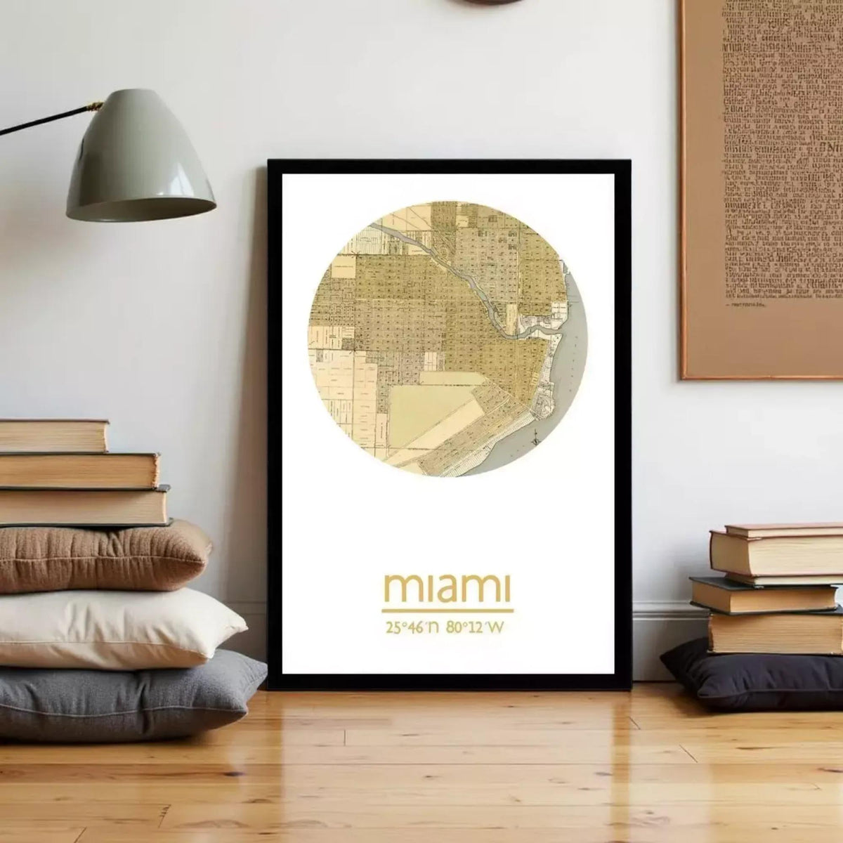 a framed map of Miami, Florida, with a stack of books and a lamp in the background.