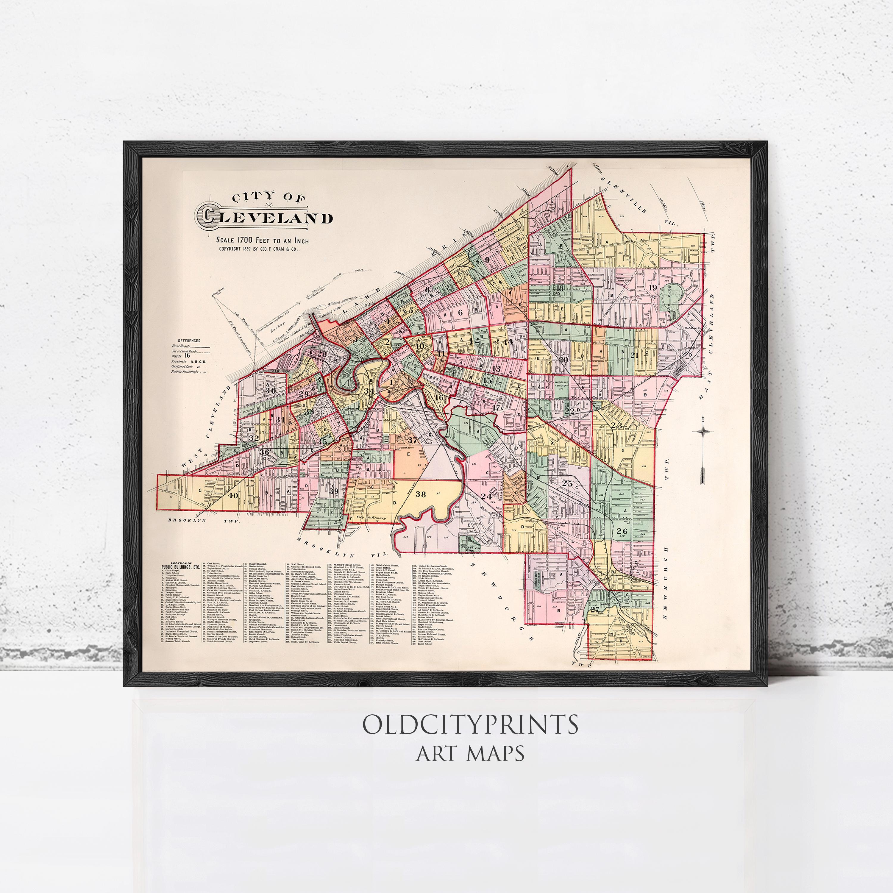 The image is a framed vintage map of Cleveland, Ohio, depicting the city's streets and neighborhoods in a detailed and colorful manner.