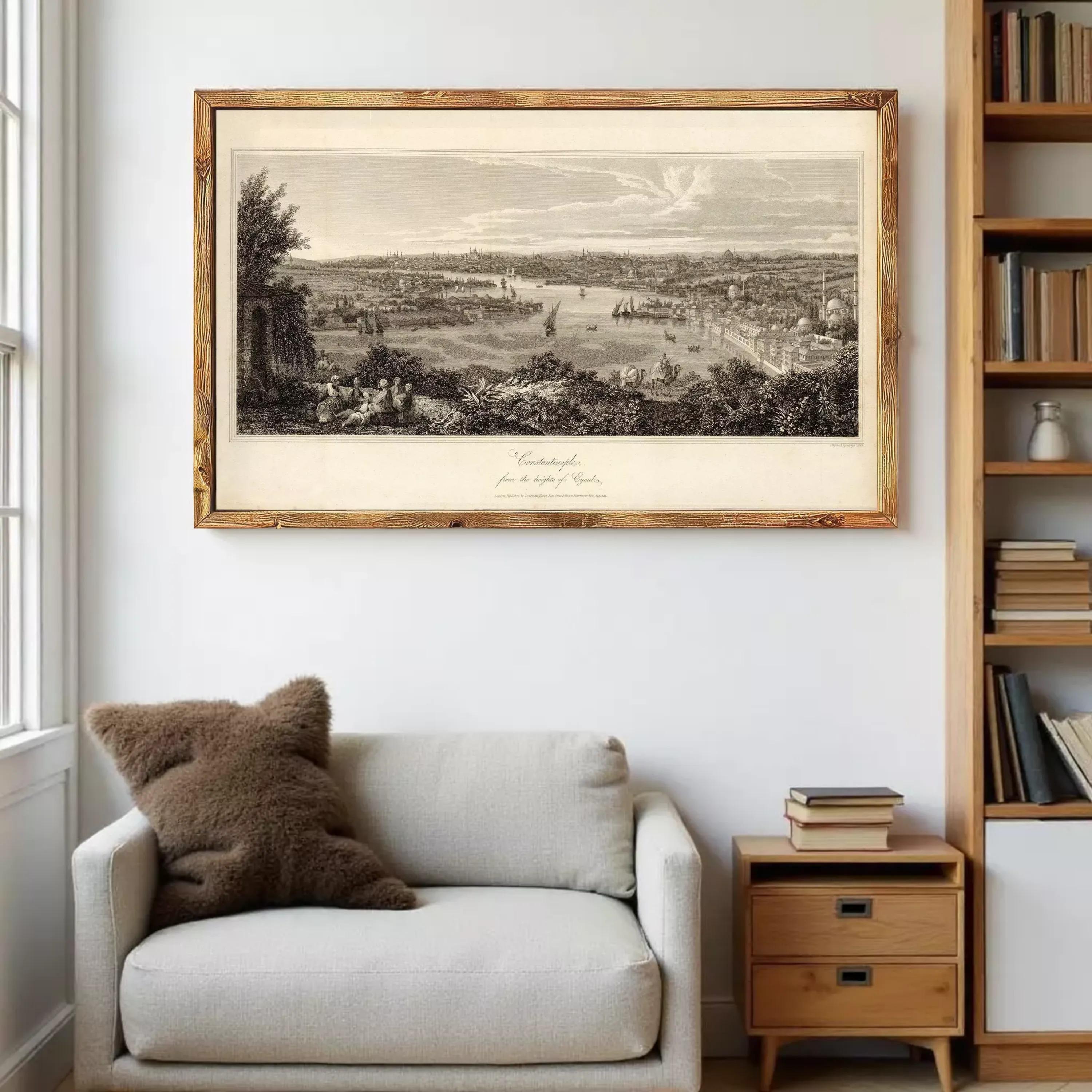 a large framed print of a landscape depicting a cityscape, hanging on a wall above a white sofa with a brown pillow.
