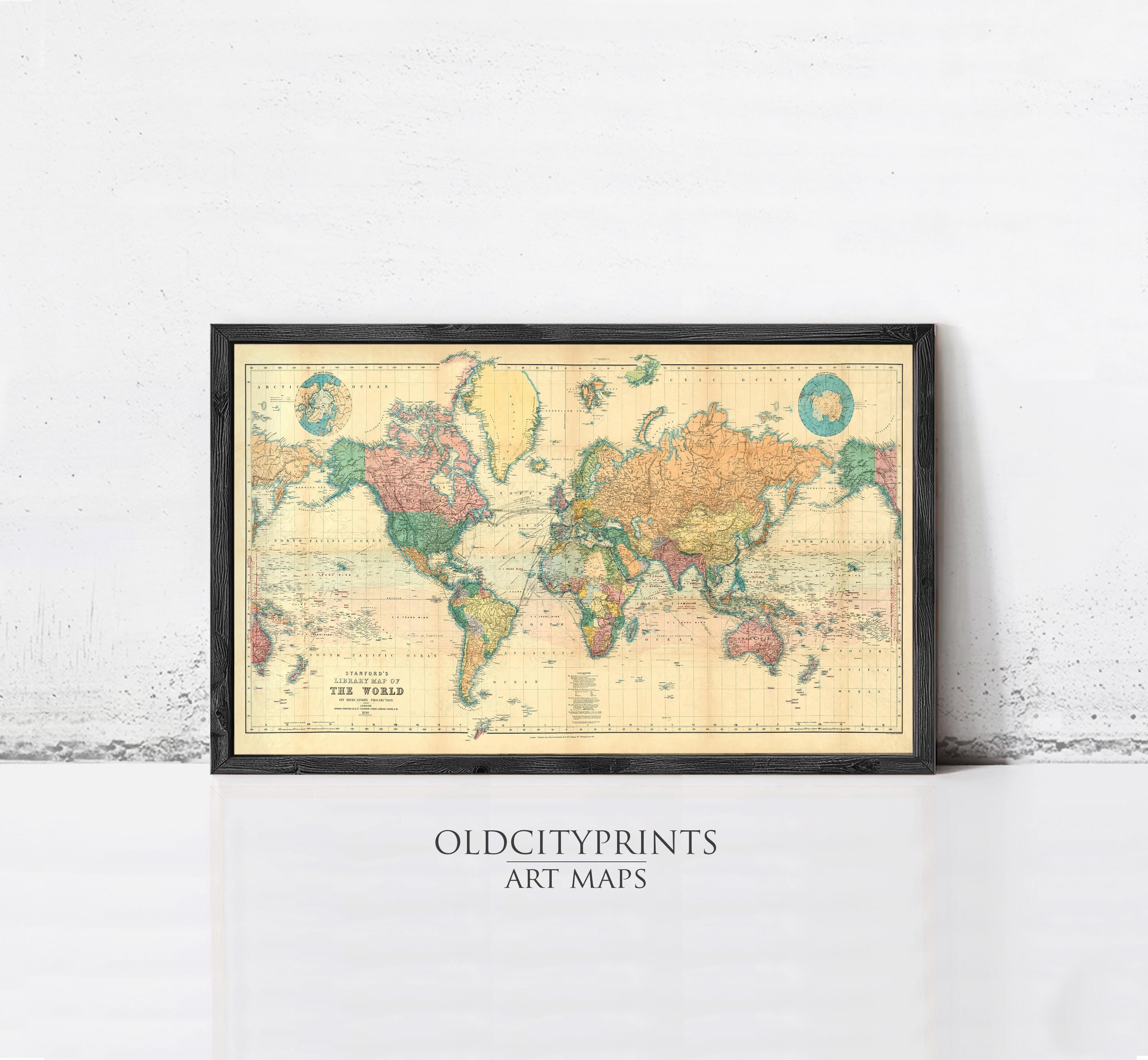 A framed vintage world map with colorful country borders and labels, displayed on a white wall.
