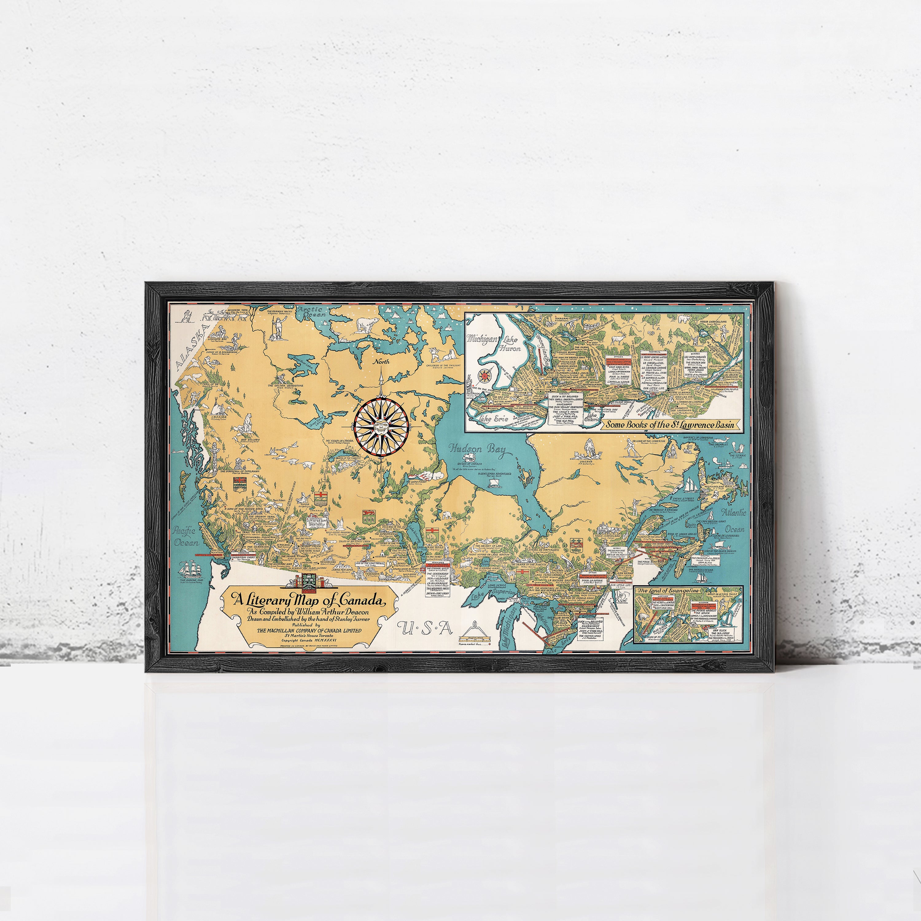 A framed map of Canada, depicting various regions and landmarks, is displayed on a white wall.