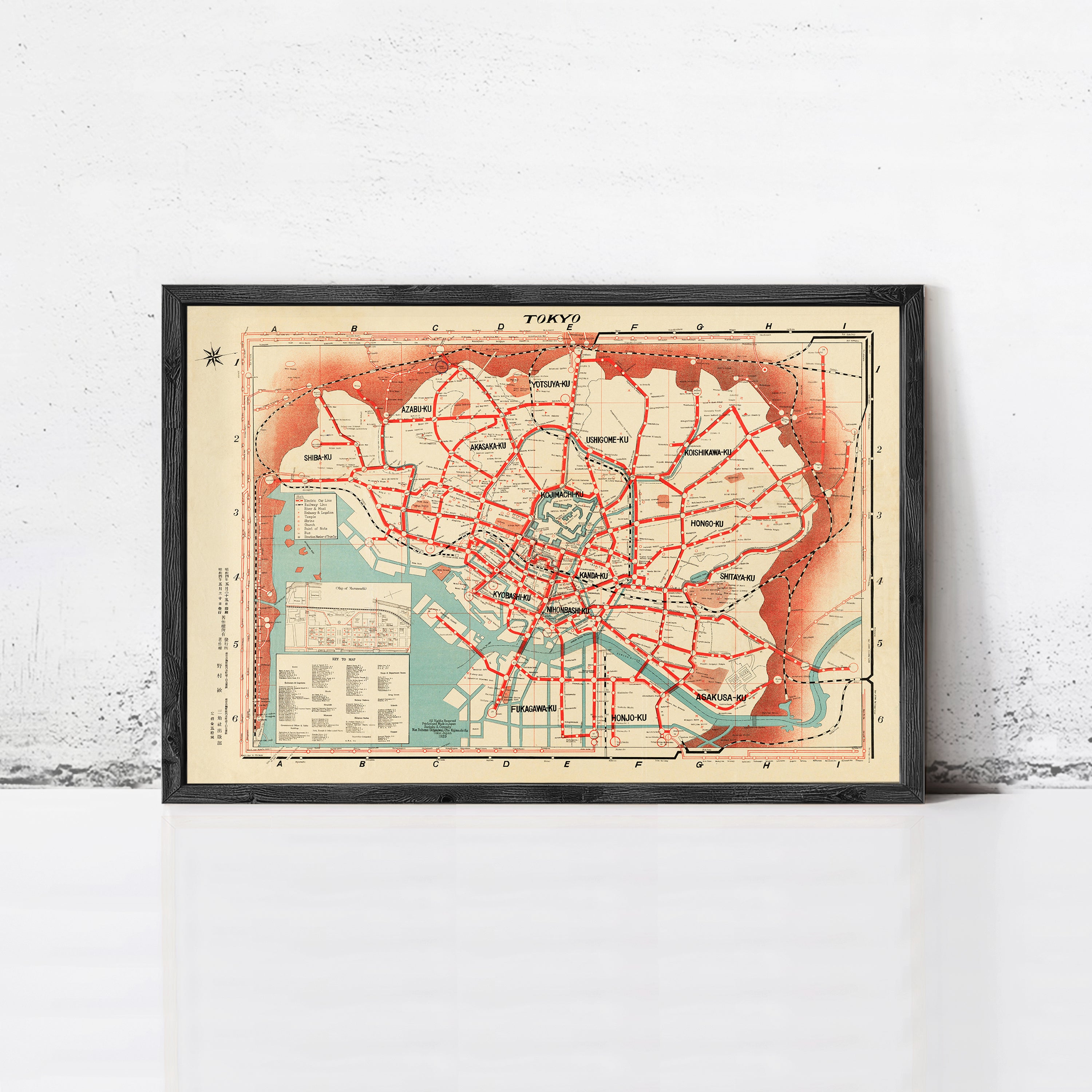 The image is a framed vintage map of Tokyo, Japan, depicting the city's streets and transportation system.