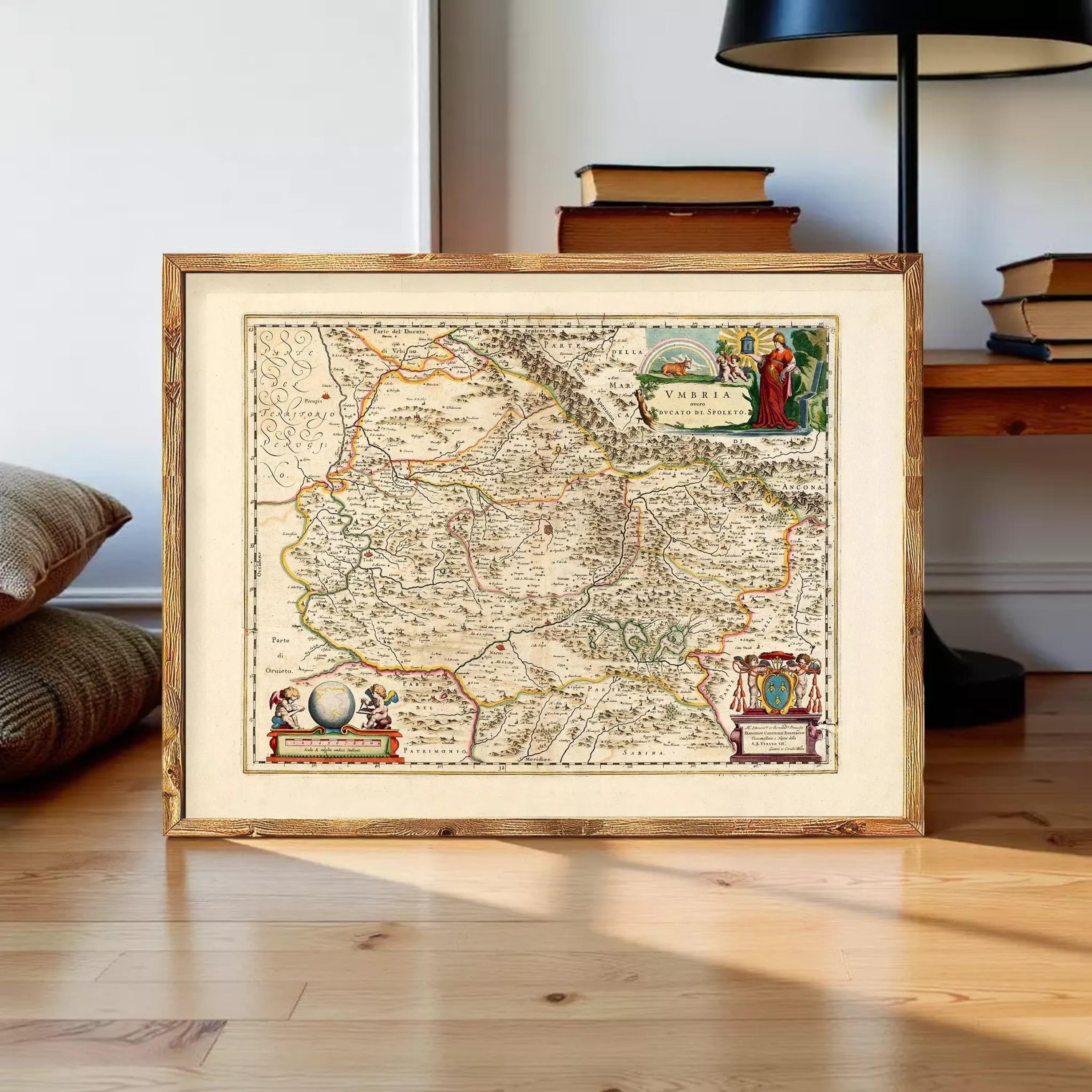 a framed map of a region, with a wooden floor and a lamp in the background.