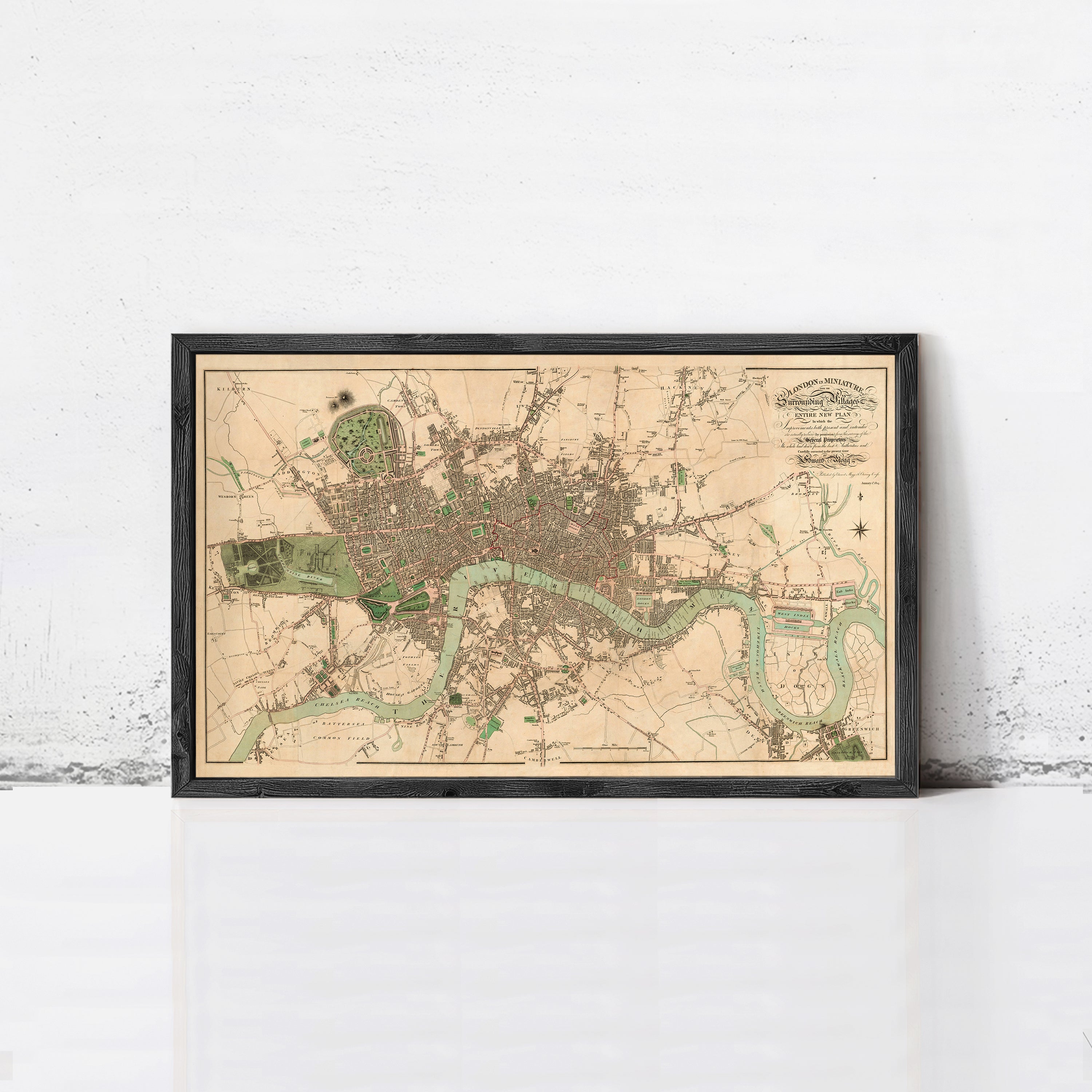 The image is a framed map of London, England, depicting the city's streets, landmarks, and surrounding areas.