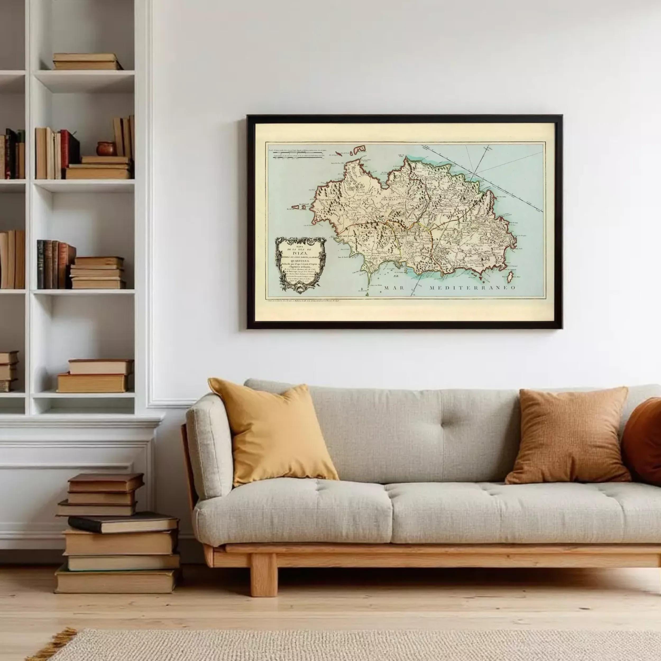 a cozy living room with a gray sofa, a bookshelf filled with books, and a framed map hanging on the wall.