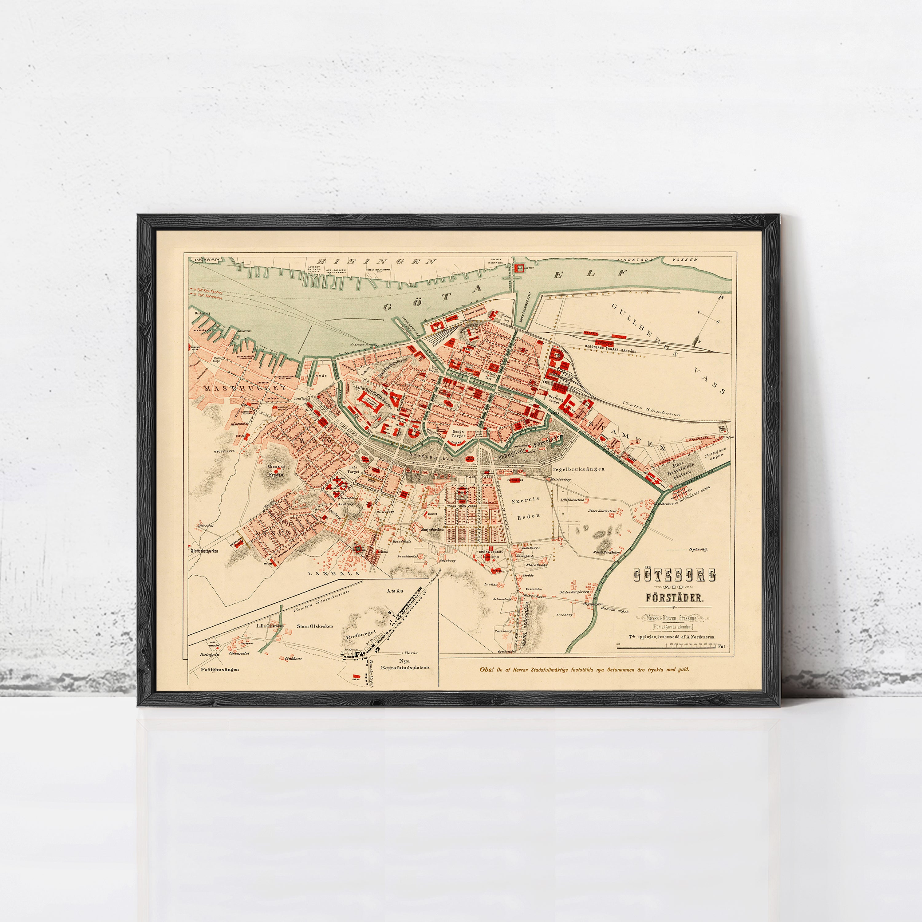 The image is a framed vintage map of a city, likely from the 19th century, depicting the city's layout and surrounding areas.