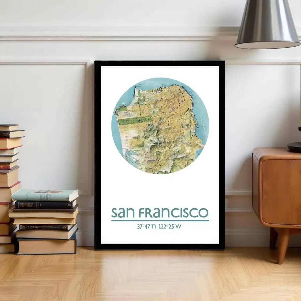 A framed map of San Francisco, with the city's location and surrounding areas, is displayed on a wall next to a stack of books and a wooden cabinet.