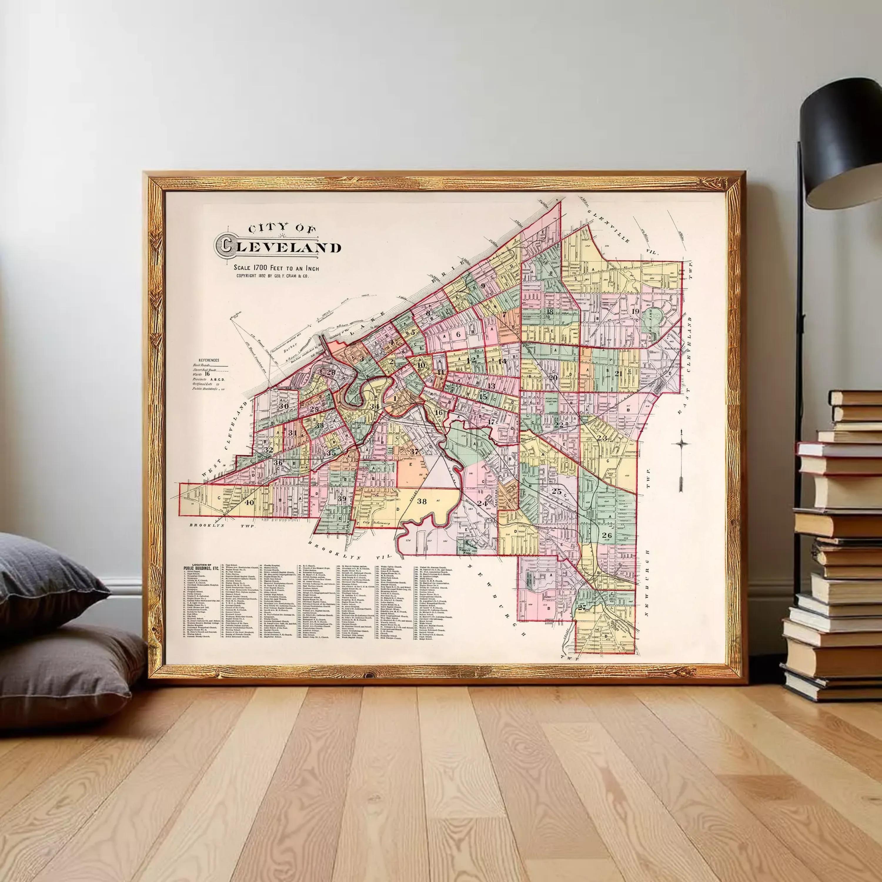The image is a framed vintage map of Cleveland, Ohio, depicting the city's streets and neighborhoods in a detailed and colorful manner.