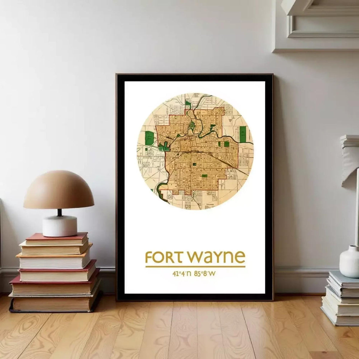 A framed map of Fort Wayne, Indiana, with the text "Fort Wayne" and a coordinate system, is displayed on a wall next to a stack of books and a lamp.