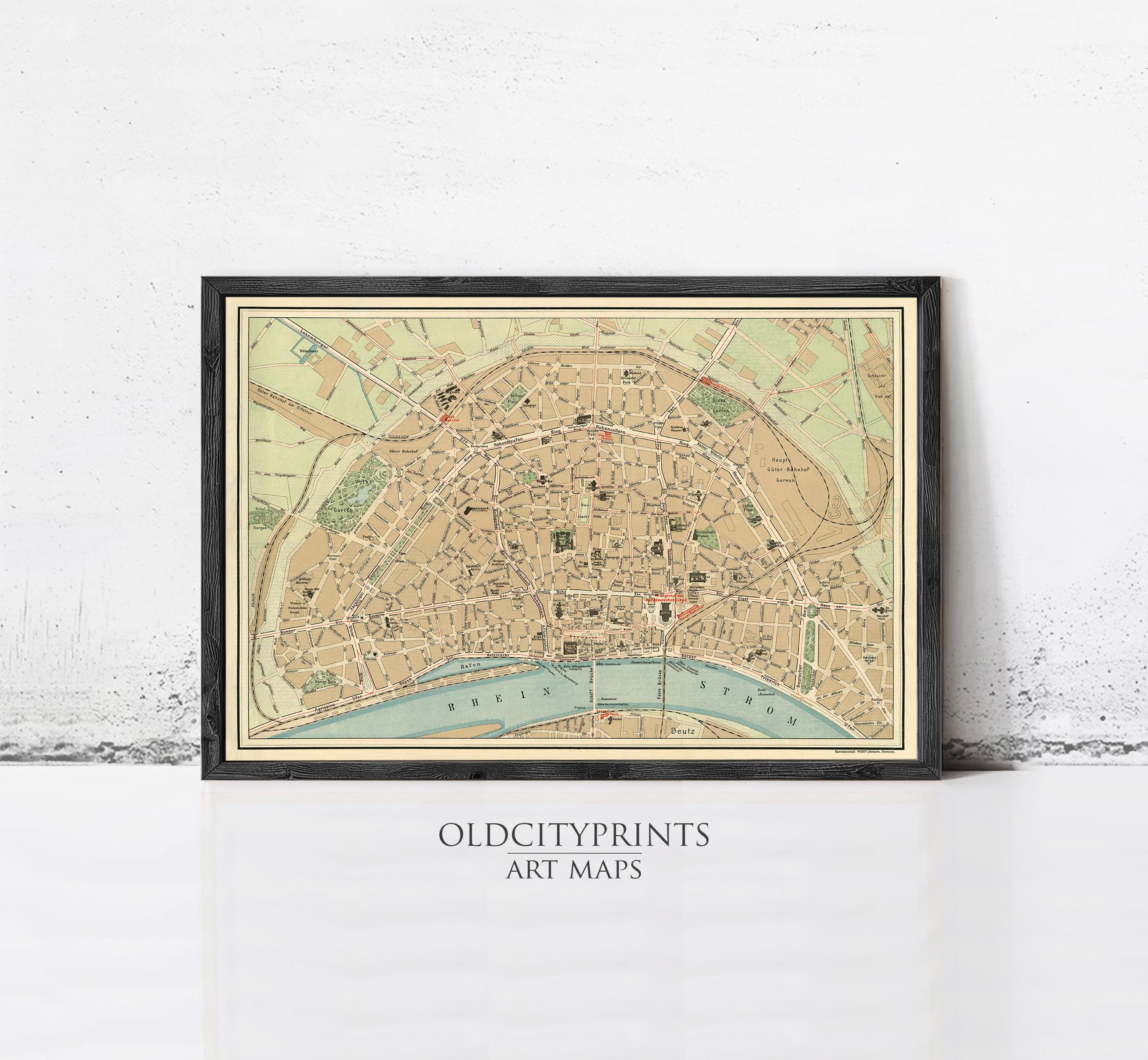 The image is a framed vintage map of a city, likely Paris, with various streets and landmarks depicted.