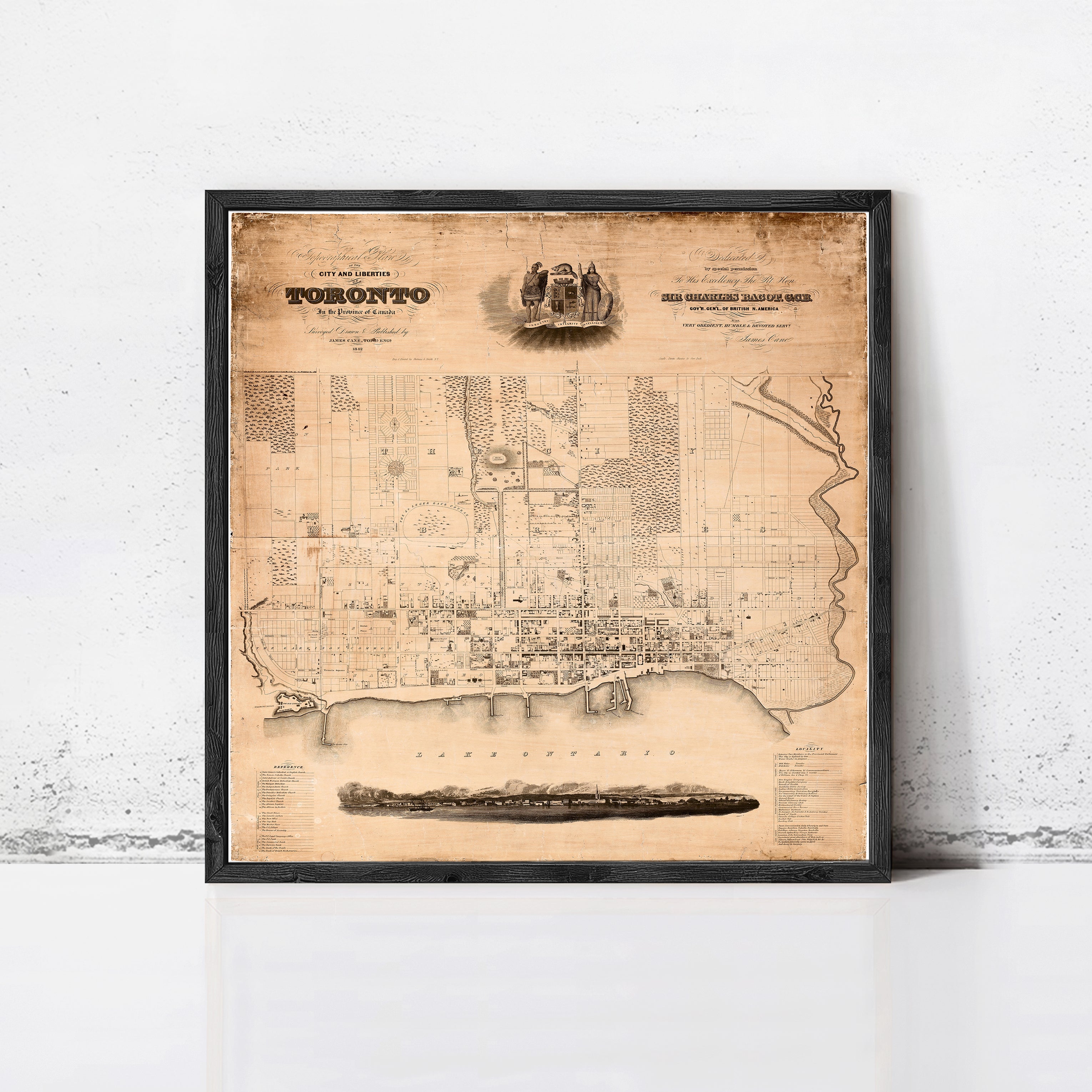 The image is a framed vintage map of Toronto, Canada, depicting the city's layout and surrounding areas.