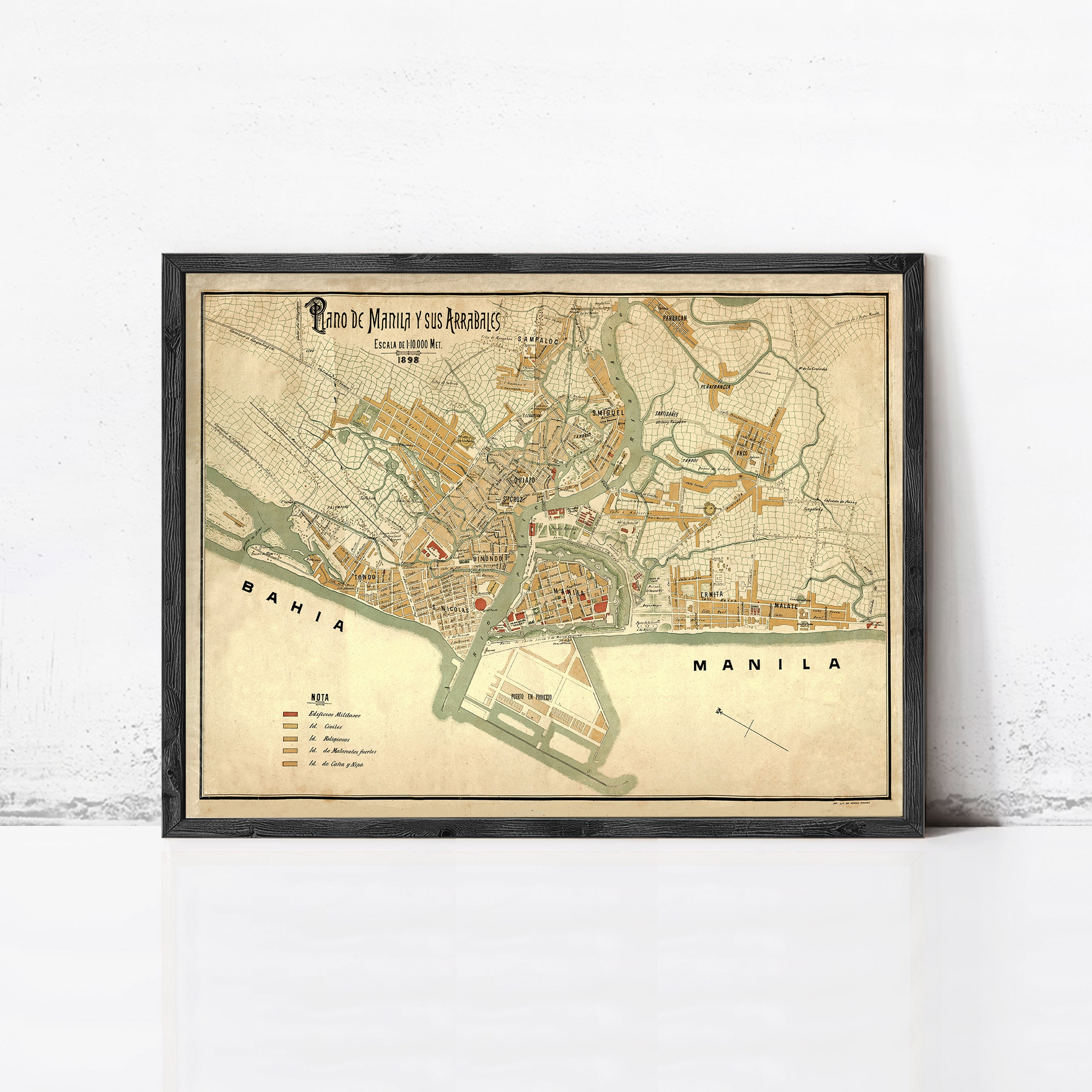 The image is a framed vintage map of Manila, Philippines, depicting the city's layout and surrounding areas.